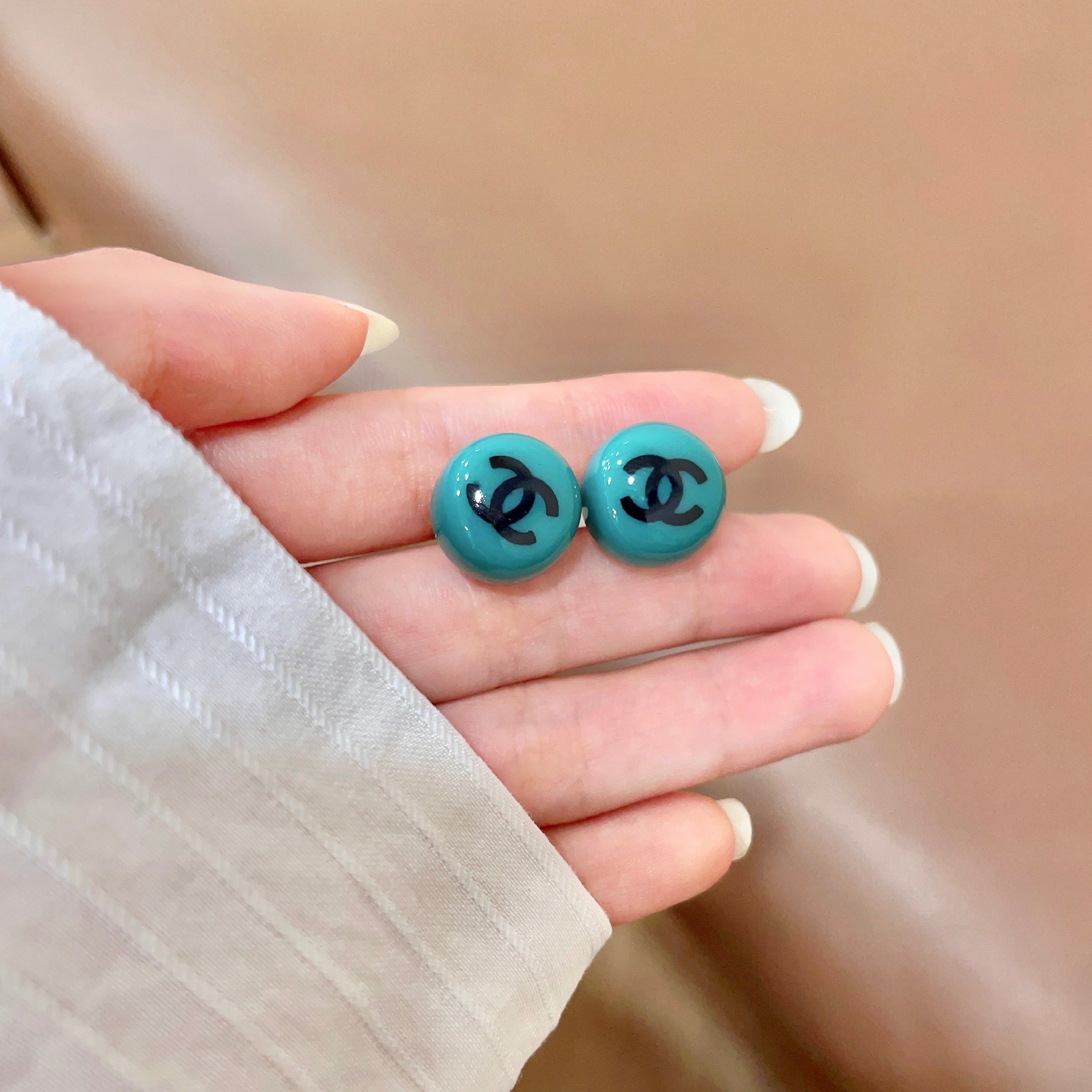 Chanel CC Logo Round Stud Earrings earrings Turquoise resin with black interlocking CC logo silver-toned metal hardware 1 2cm diameter