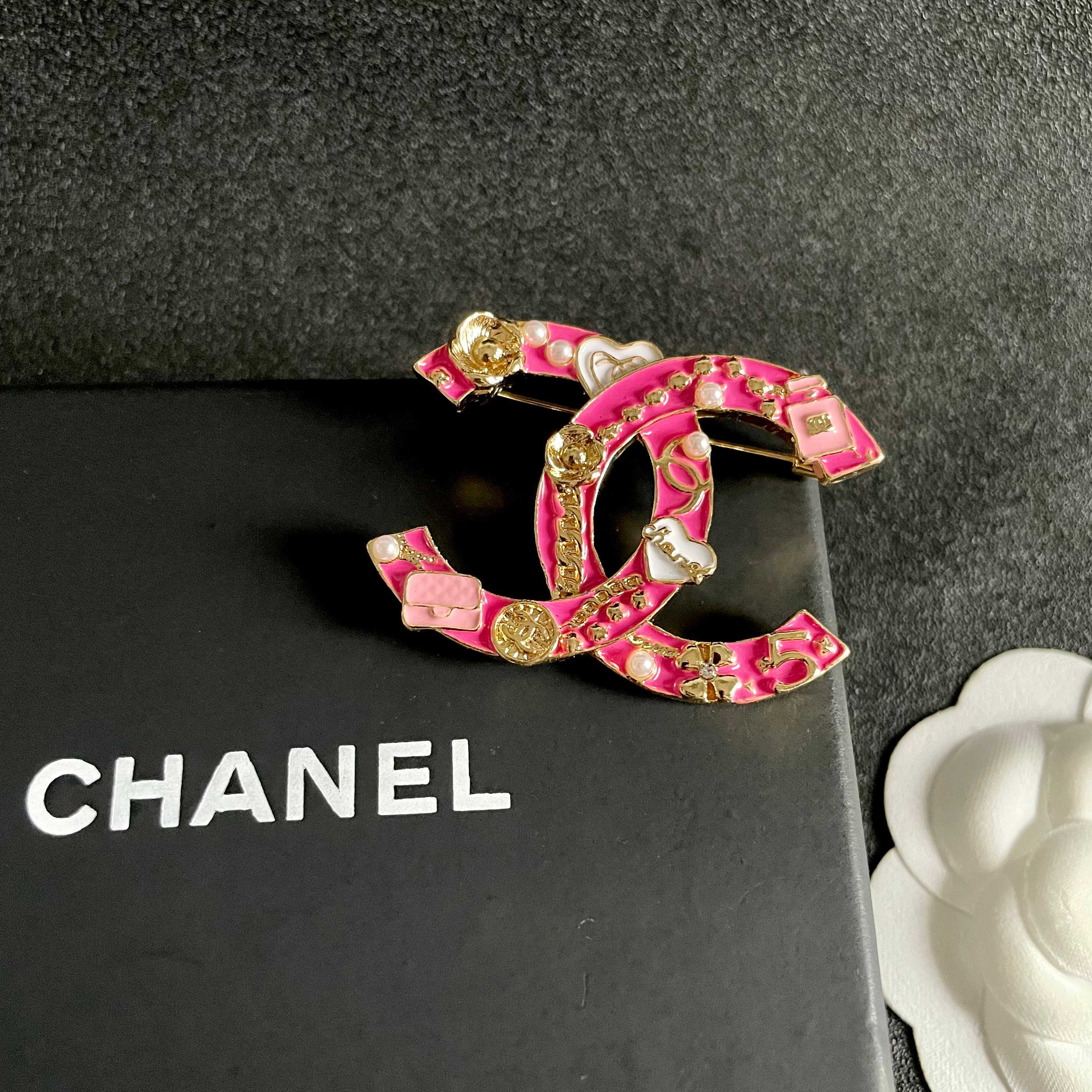 Chanel CC Logo Charms Brooch brooch Gold-tone metal with hot pink enamel white enamel accents white faux pearls 4cm width