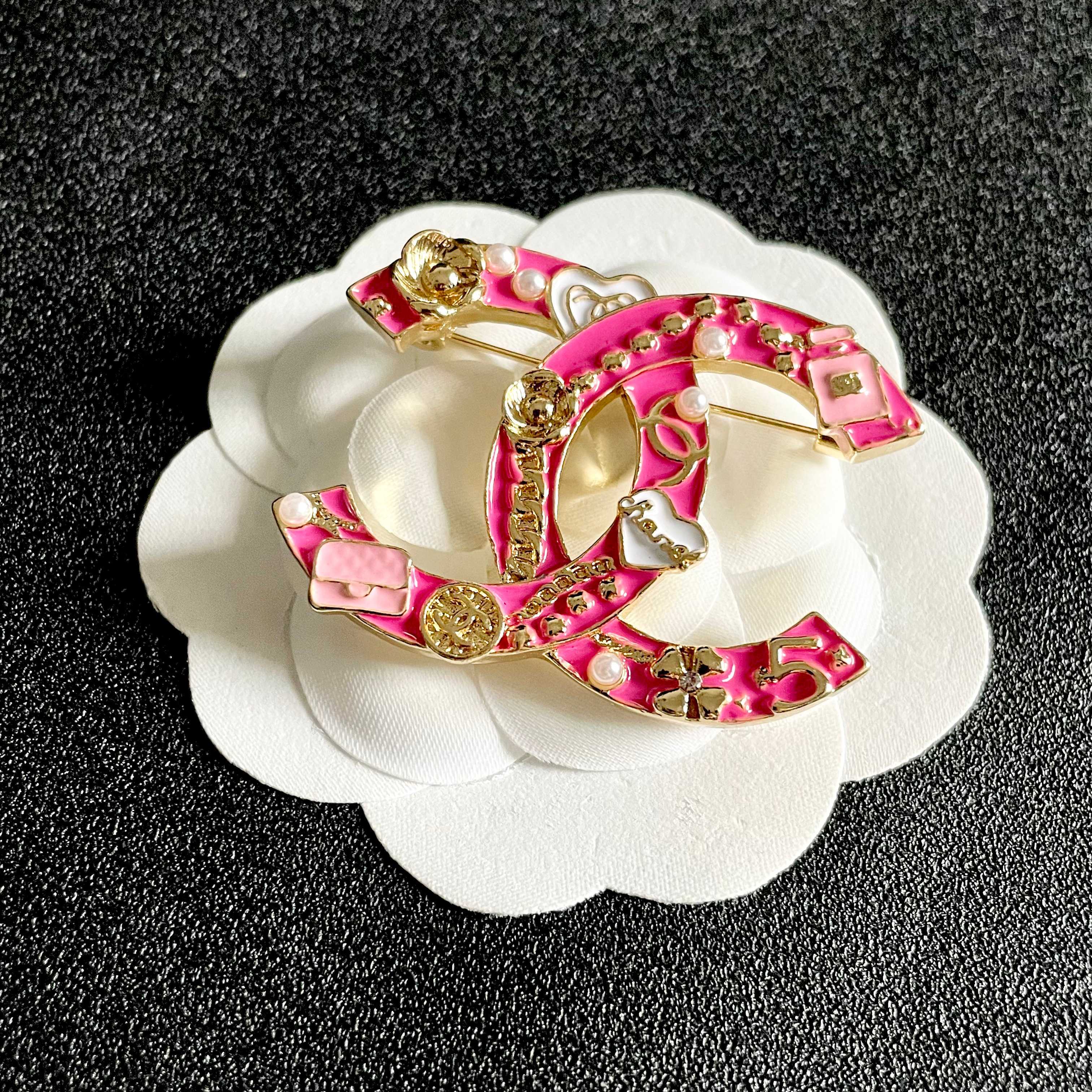 Chanel CC Logo Charms Brooch brooch Gold-tone metal with hot pink enamel white enamel accents white faux pearls 4cm width