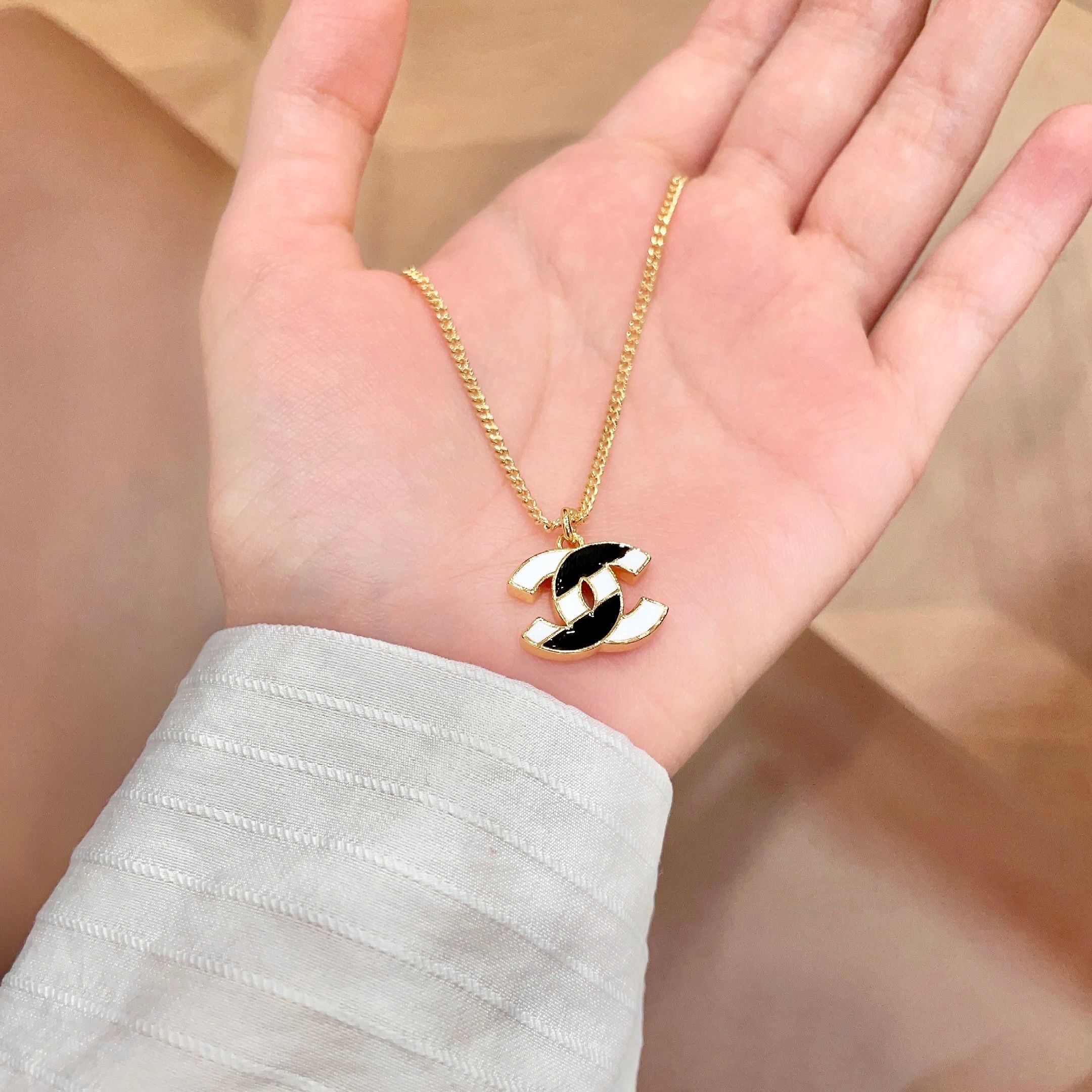 Chanel CC Logo Enamel Pendant necklace gold-tone metal with black and white enamel 42cm