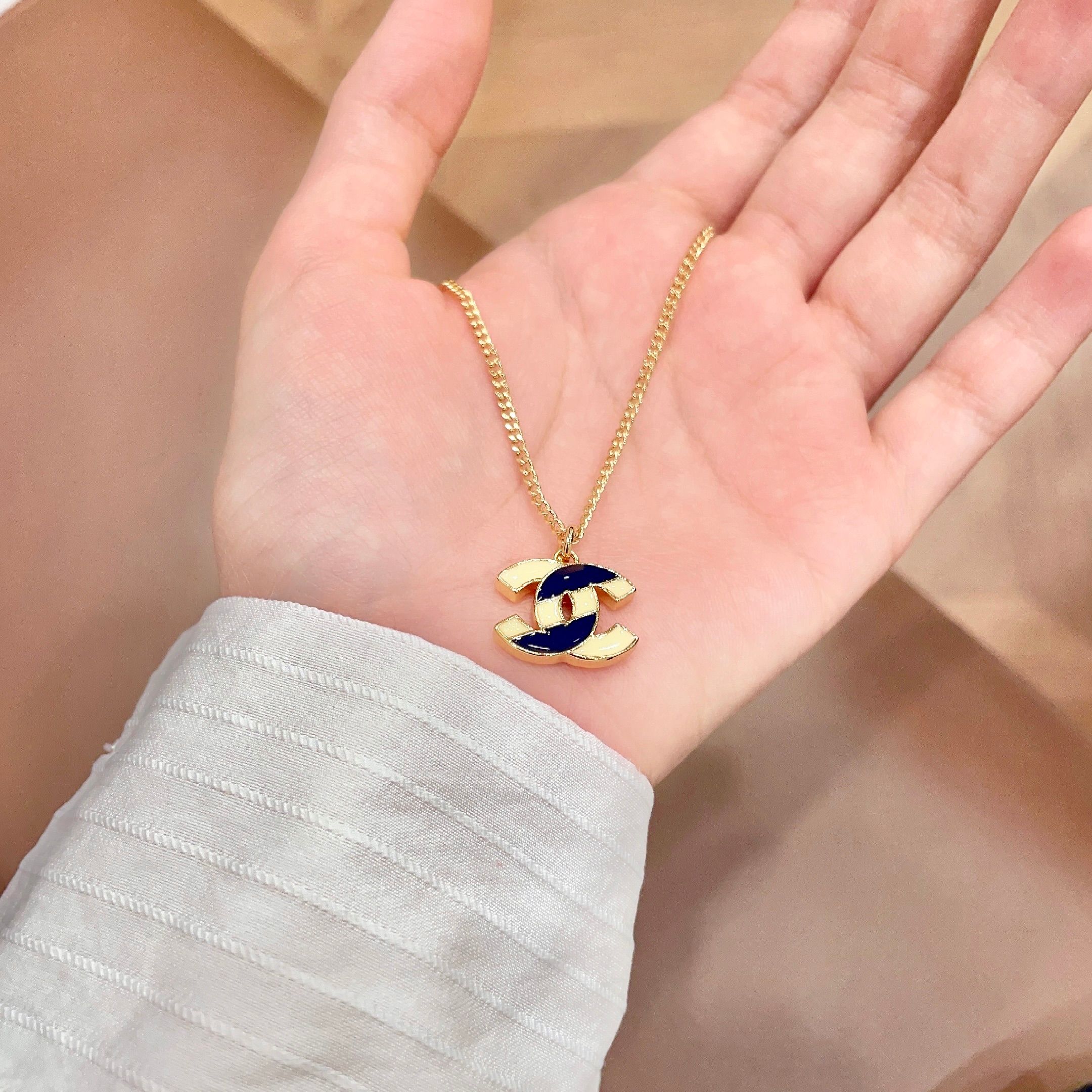 Chanel CC Enamel Pendant necklace Gold-tone metal with cream and navy blue enamel 42cm