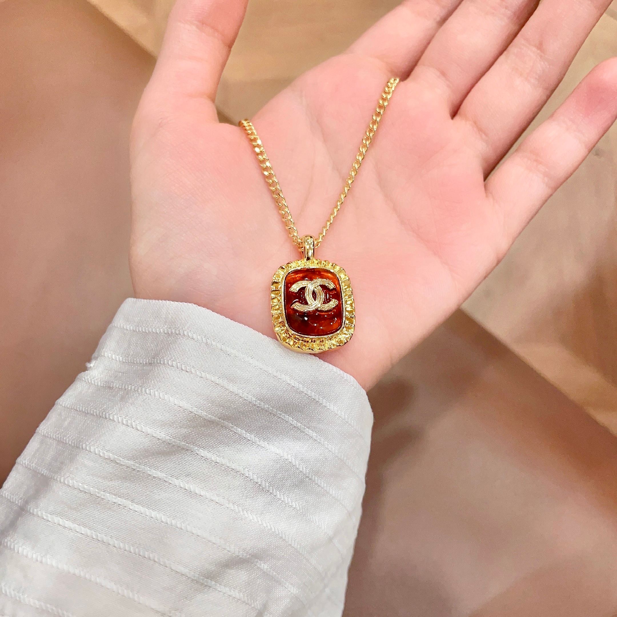 Chanel CC Logo Amber Resin Pendant necklace Gold-tone metal with amber orange resin 45cm
