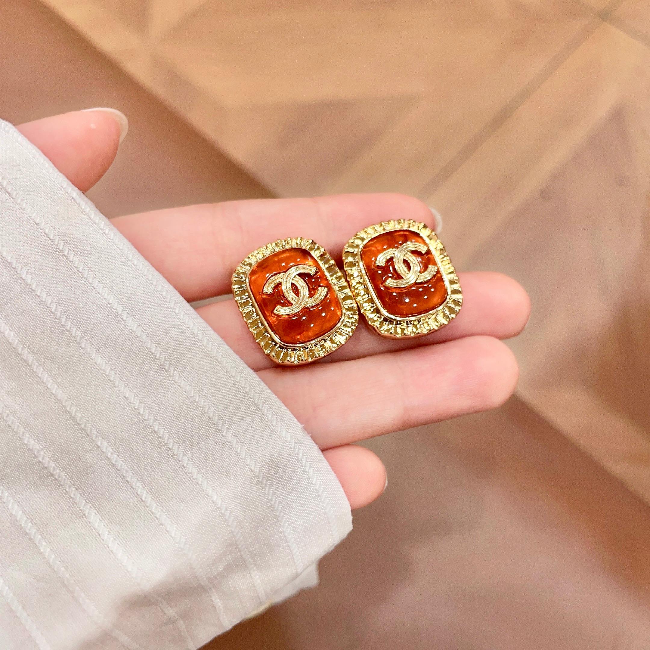 Chanel CC Logo Ribbed Edge Resin Stud Earrings earrings gold-tone metal orange resin 2cm diameter