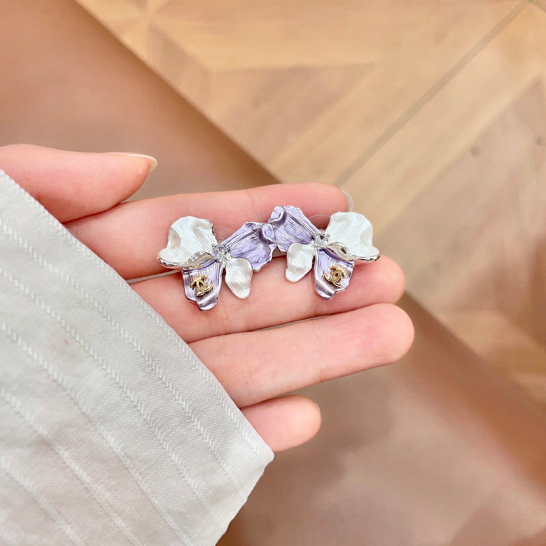 Chanel CC Logo Iridescent Flower Stud Earrings earrings Silver-toned metal pearlescent white lavender purple rose gold CC logo clear crystal accent white pearl accent 2cm stud diameter