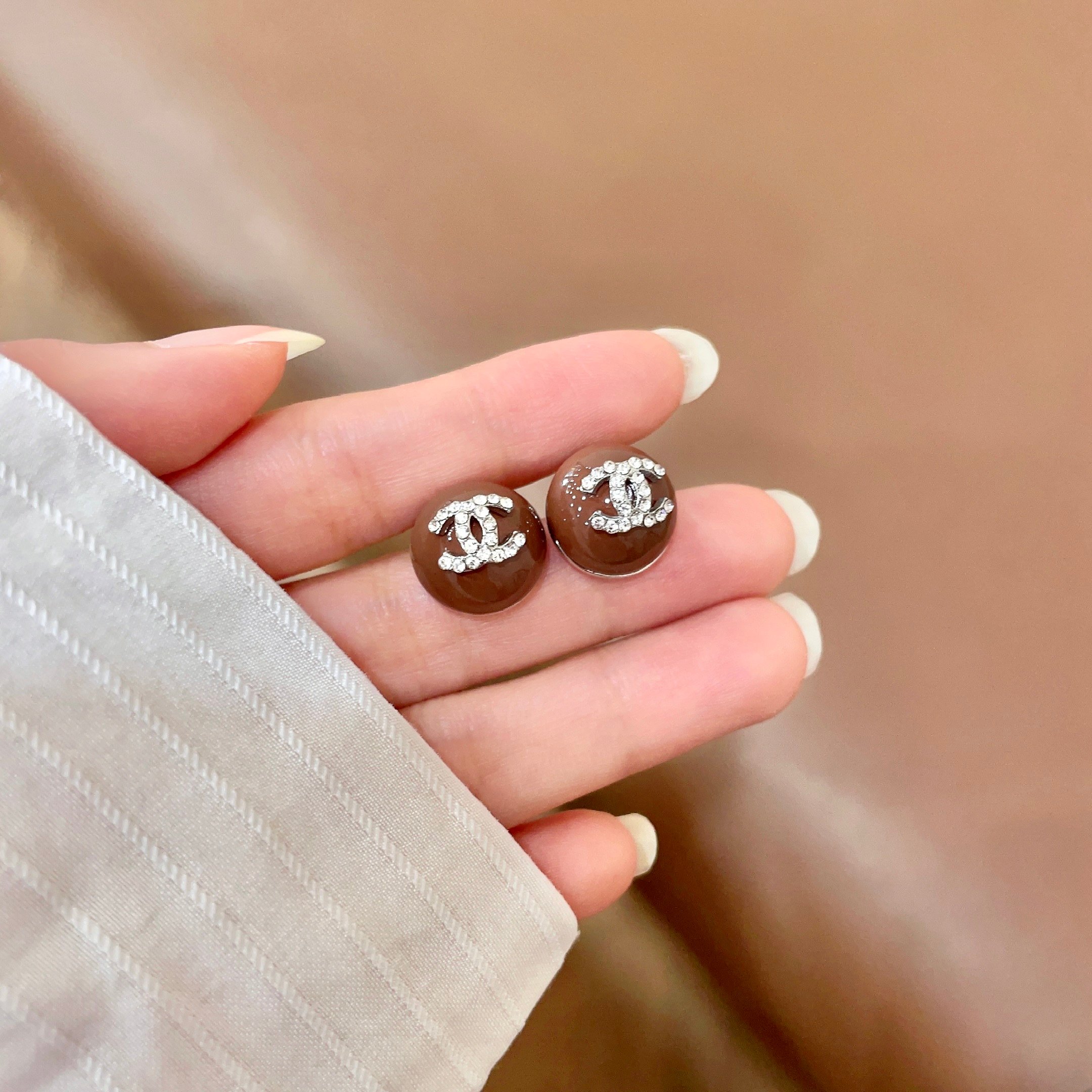 Chanel CC Logo Round Stud Earrings earrings brown resin base with silver-tone metal and clear crystal CC logo 1 2cm diameter