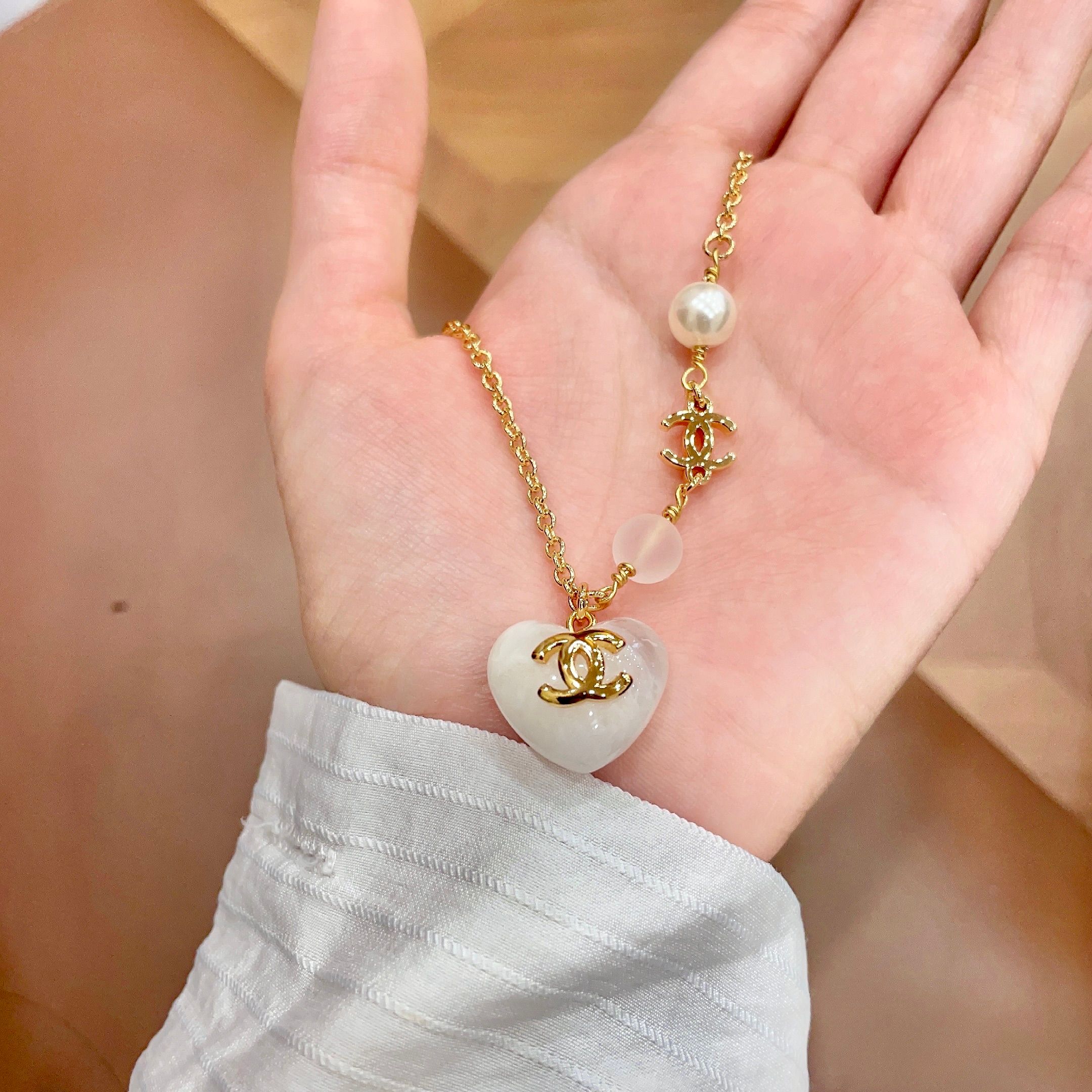 Chanel CC Heart Pendant necklace Gold-tone metal white resin heart white faux pearl frosted white bead 42cm