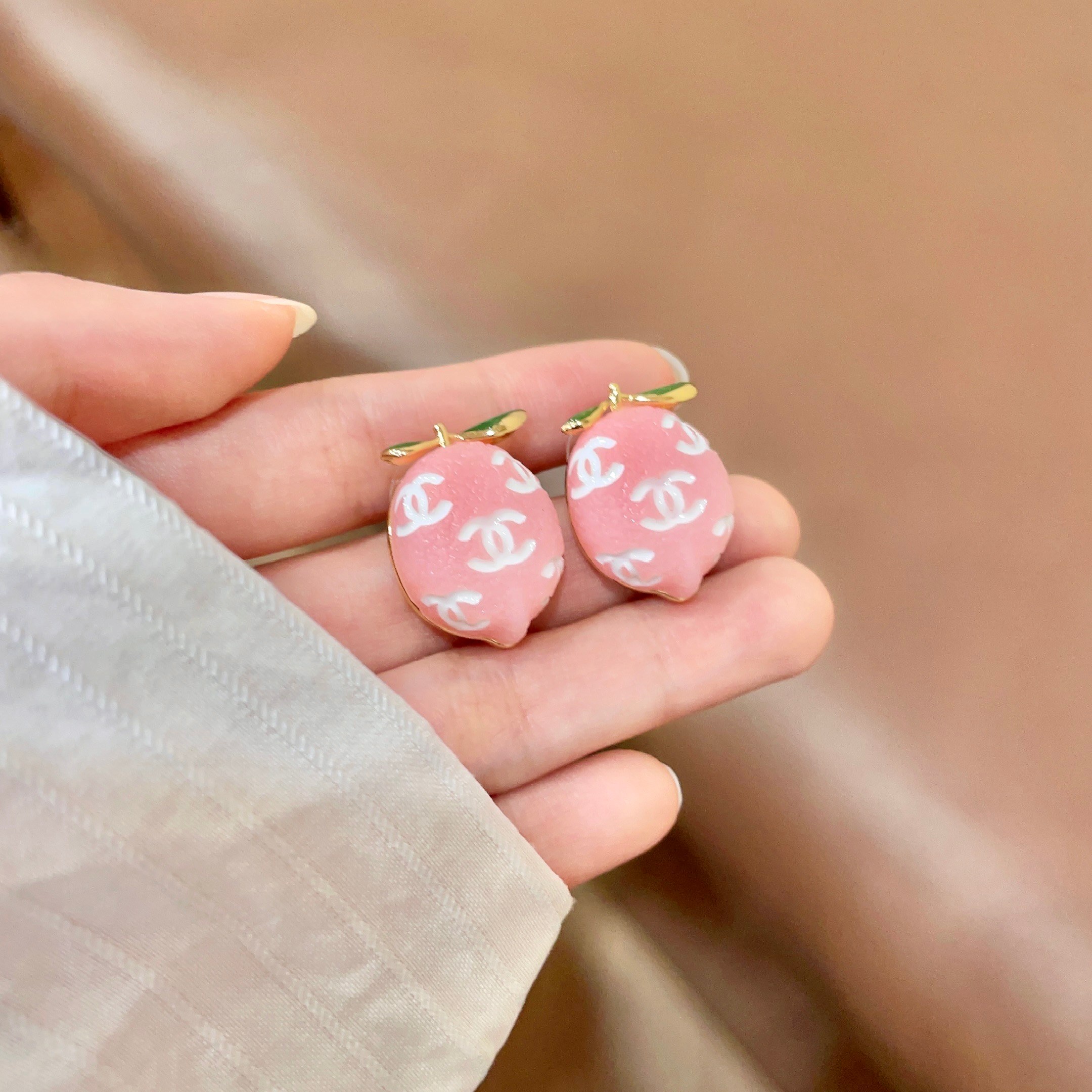 Chanel CC Lemon Fruit Stud Earrings earrings Gold-tone metal pink resin with white interlocking CC logos green enamel leaf accents One Size approx 2cm drop length
