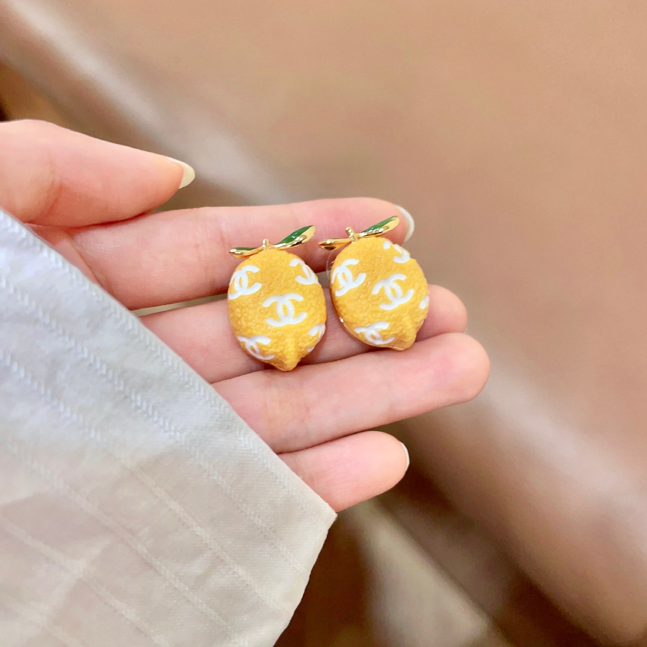 Chanel CC Lemon Fruit Stud Earrings earrings Gold tone metal yellow enamel lemon body white enamel CC logos green enamel leaves 1 5cm stud diameter