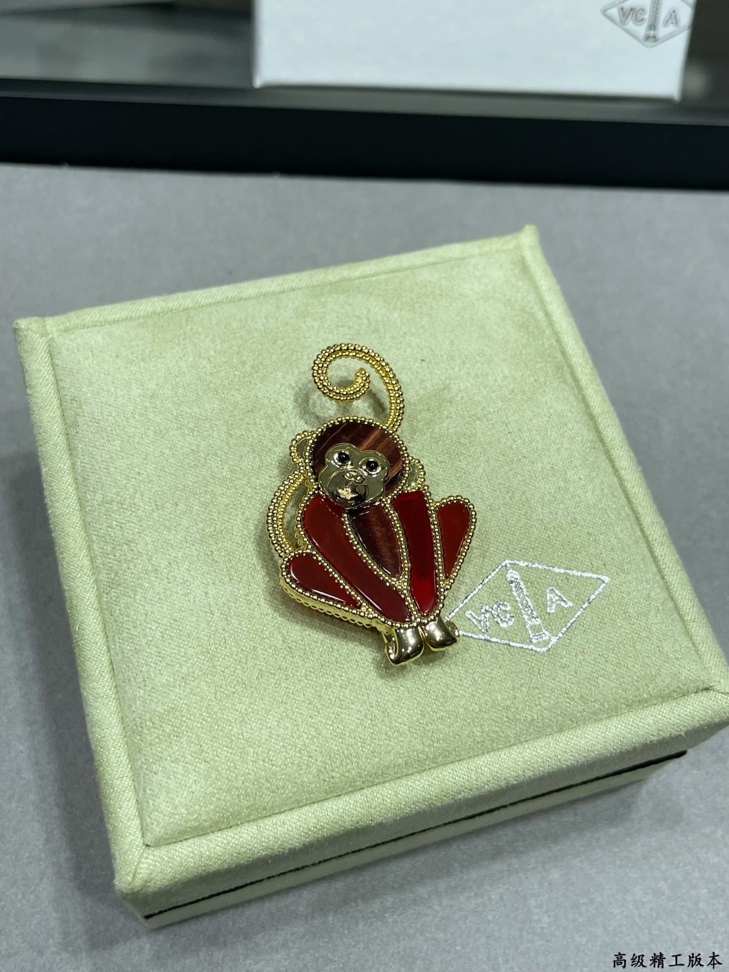 Van Cleef Arpels Lucky Animals Monkey brooch Yellow gold red carnelian brown wood black onyx 30mm x 20mm