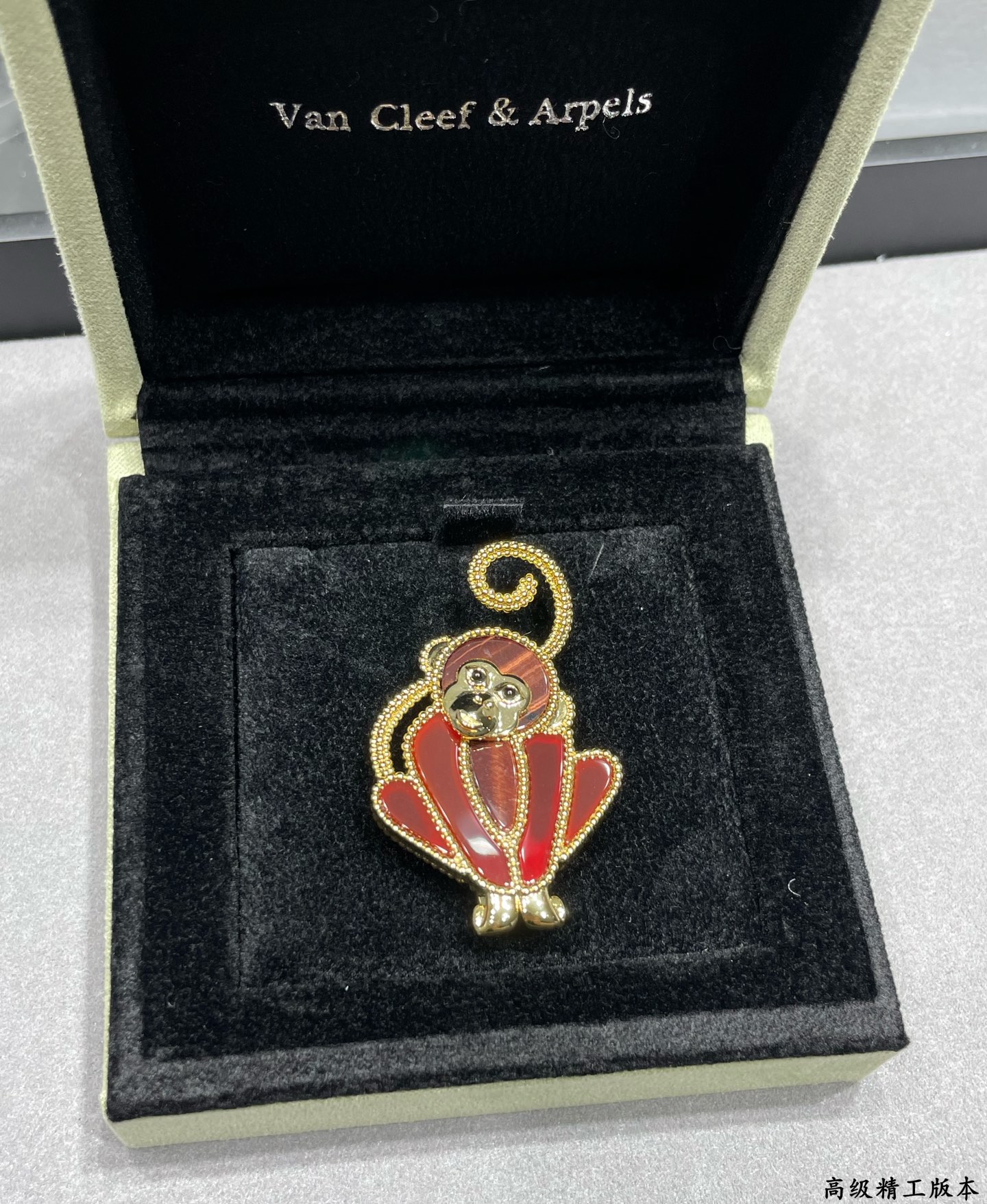 Van Cleef Arpels Lucky Animals Monkey brooch Yellow gold red carnelian brown wood black onyx 30mm x 20mm
