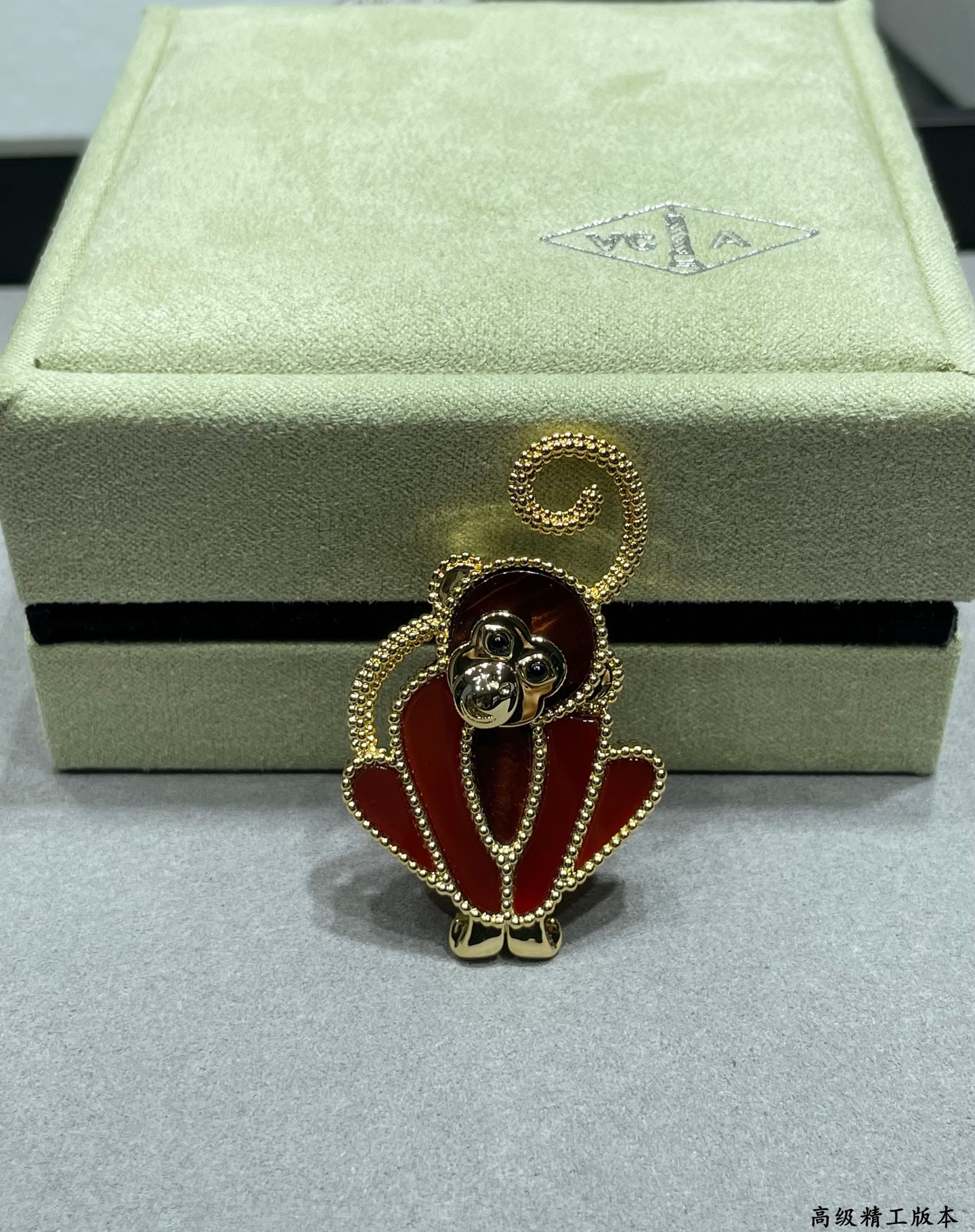 Van Cleef Arpels Lucky Animals Monkey brooch Yellow gold red carnelian brown wood black onyx 30mm x 20mm