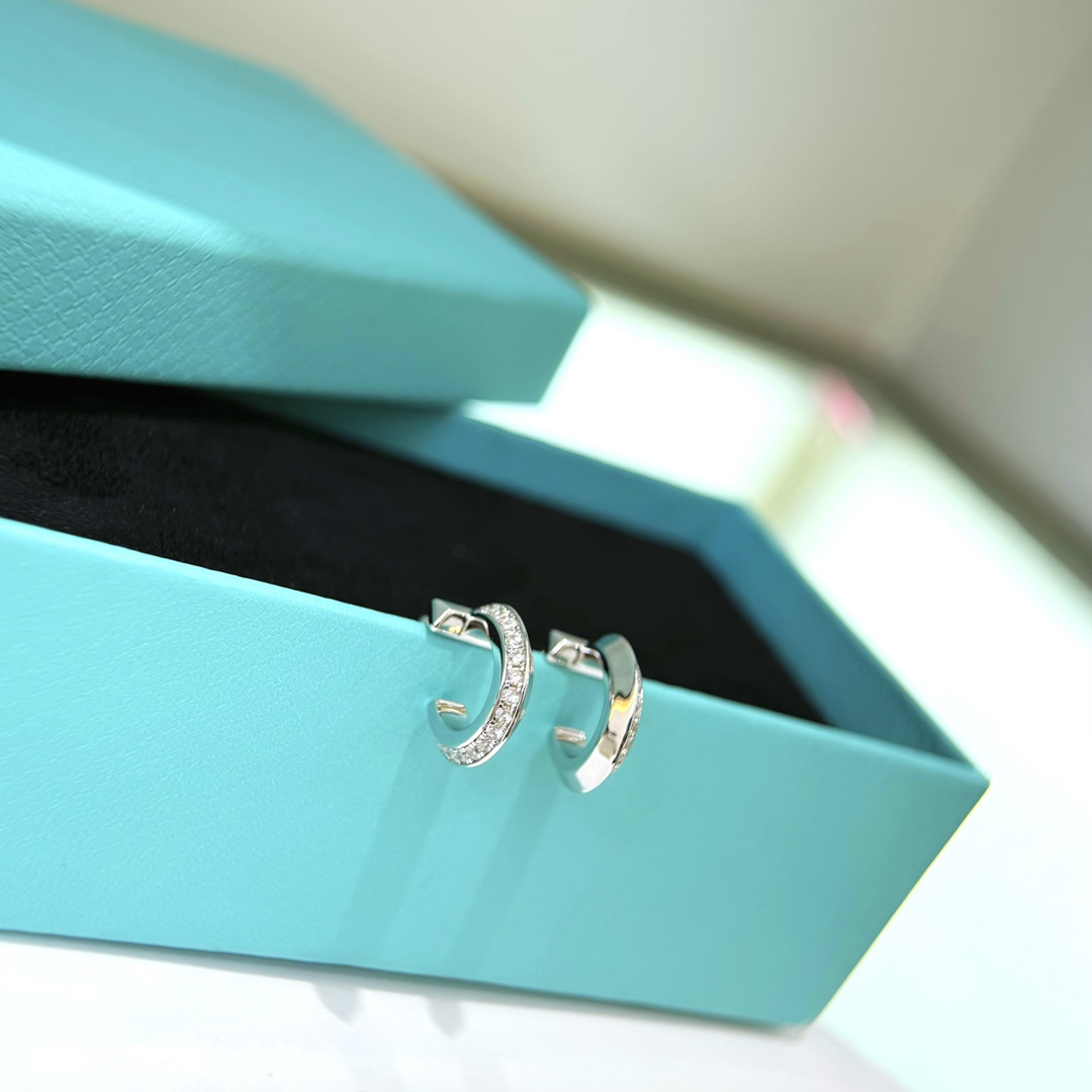 Tiffany T1 earrings silver-toned metal with clear diamond accents 12mm hoop diameter