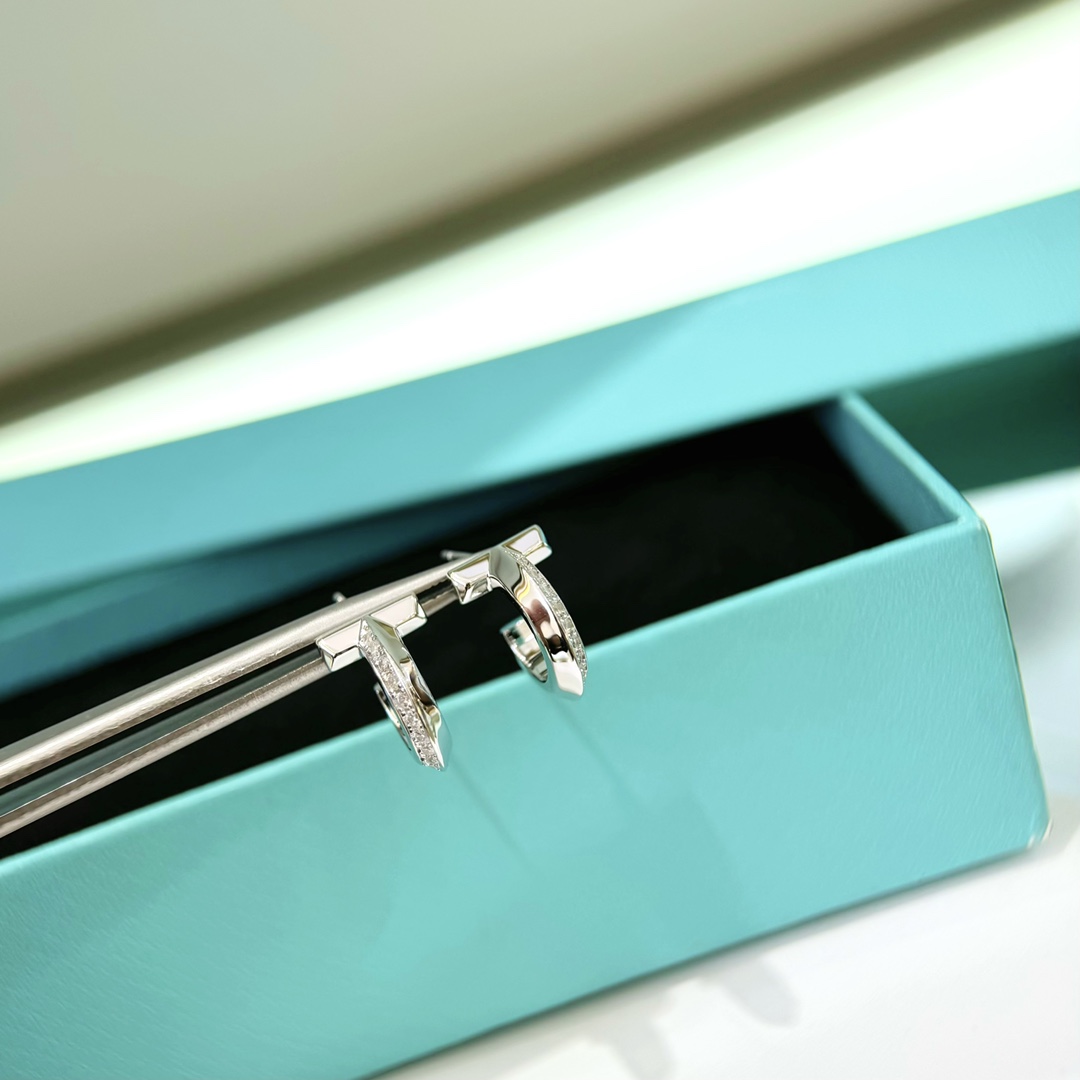 Tiffany T1 earrings silver-toned metal with clear diamond accents 12mm hoop diameter