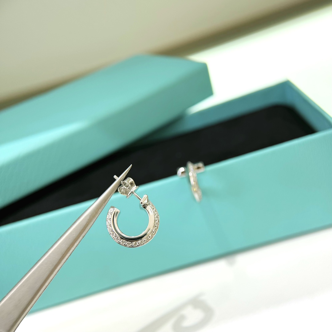 Tiffany T1 earrings silver-toned metal with clear diamond accents 12mm hoop diameter