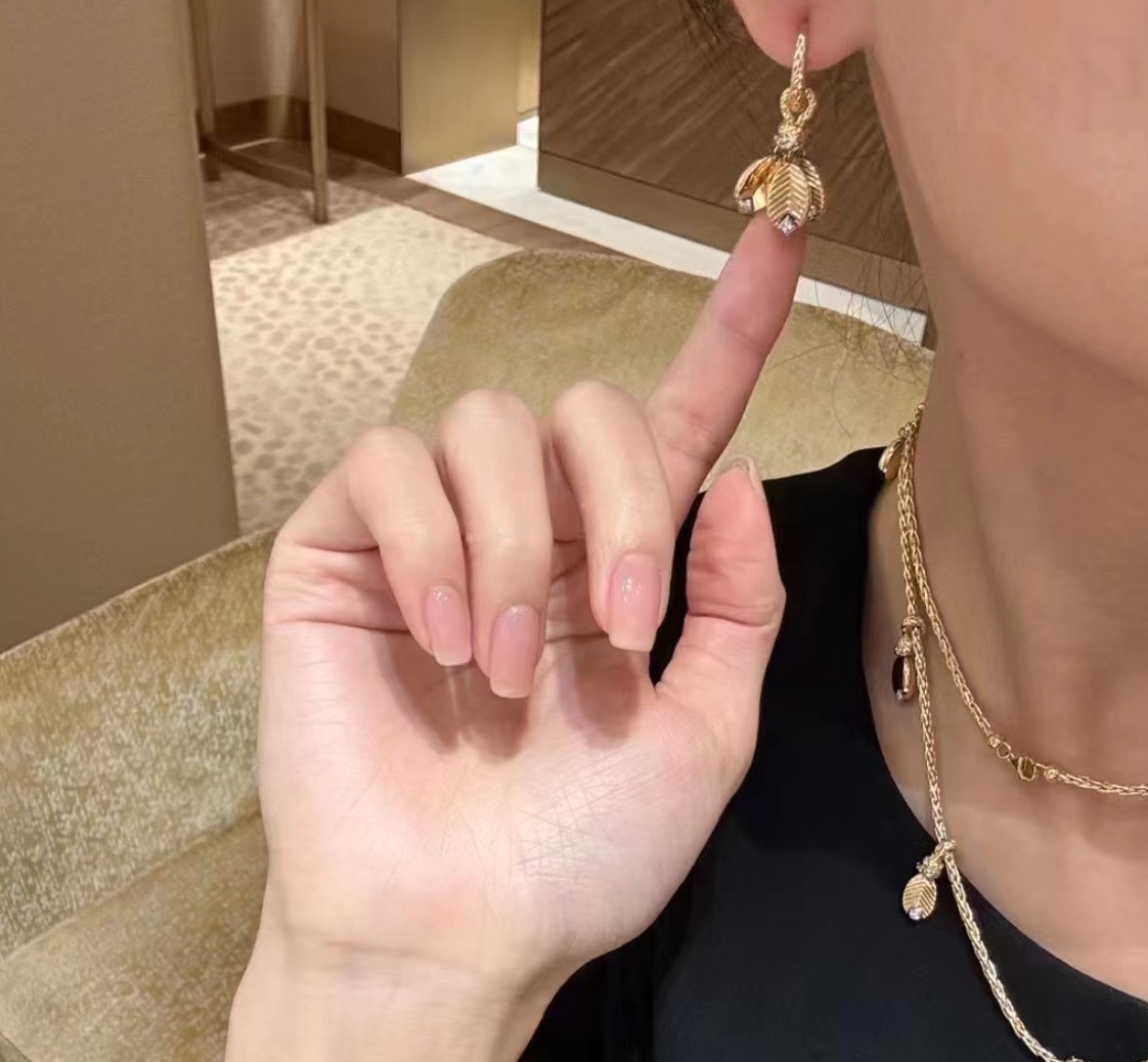 Cartier Grain de Cafe earrings Available in 18k yellow gold with white gold accents and clear diamonds 18k white gold with clear diamonds and 18k rose gold with clear diamonds One Size