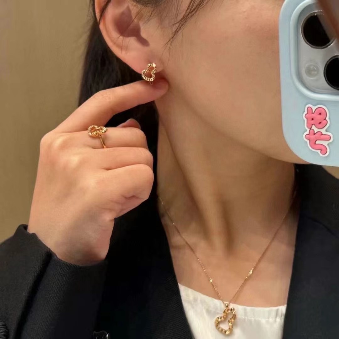 Qeelin Wulu earrings gold tone metal with faceted detailing no gemstones 10mm hoop diameter