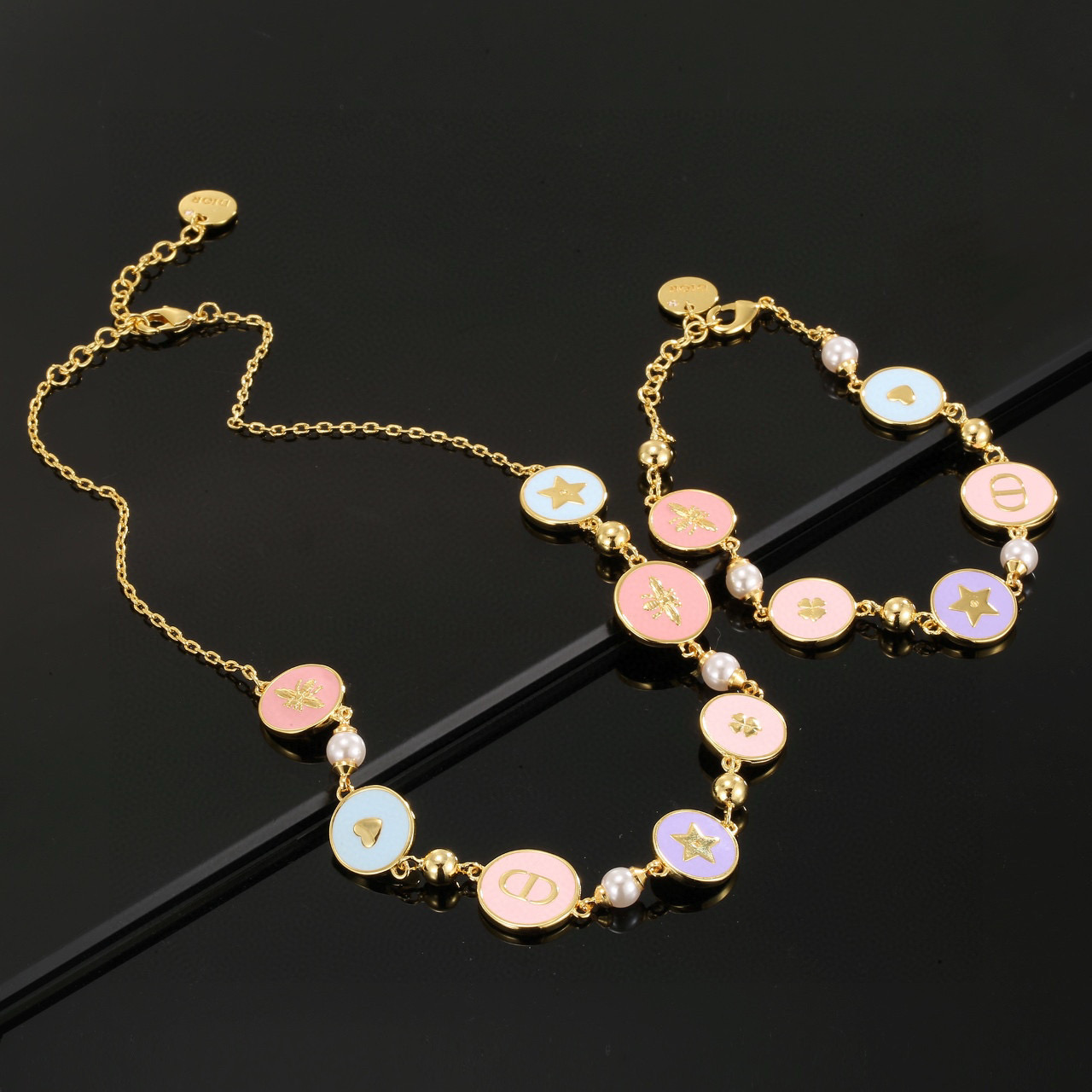 Dior Lucky Charms Enamel Medallion Bracelet bracelet Gold-tone metal with white faux pearls pastel pink light blue lavender enamel and gold-toned charm details 18cm with 3cm extension chain