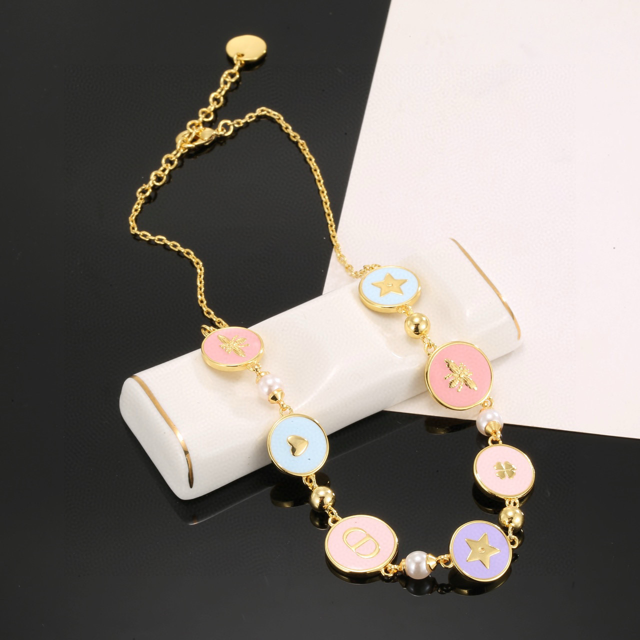 Dior Lucky Charms Enamel Medallion Bracelet bracelet Gold-tone metal with white faux pearls pastel pink light blue lavender enamel and gold-toned charm details 18cm with 3cm extension chain