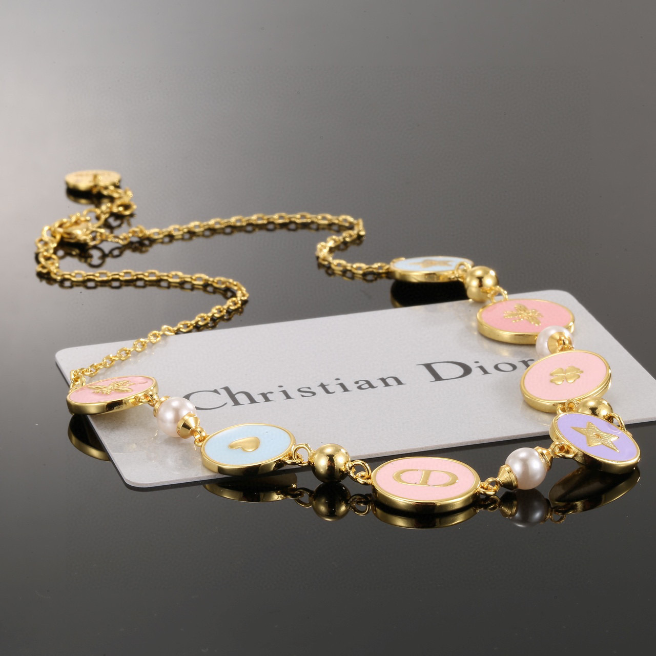 Dior Lucky Charms Enamel Medallion Bracelet bracelet Gold-tone metal with white faux pearls pastel pink light blue lavender enamel and gold-toned charm details 18cm with 3cm extension chain