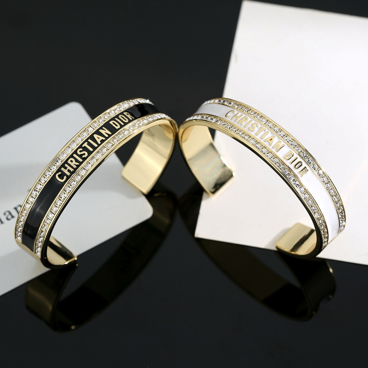Dior Christian Dior CD Signature Enamel Crystal Cuff bracelet Gold-tone metal with clear crystals available in black enamel or white enamel variants One Size open cuff standard 17cm inner circumference