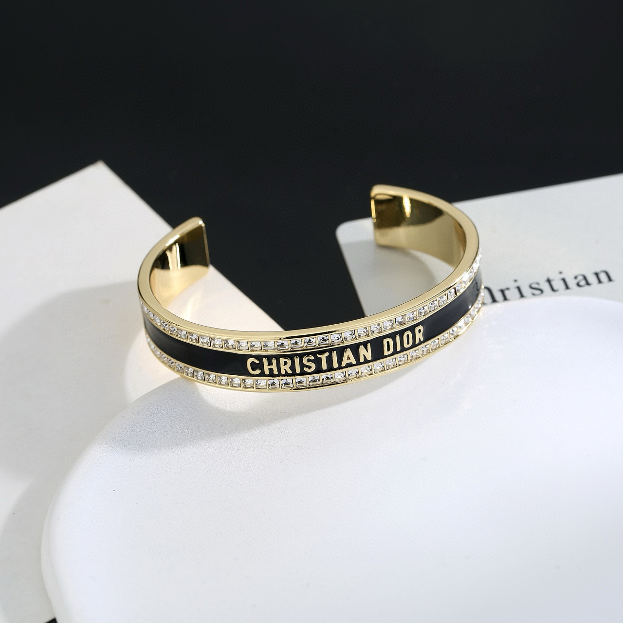 Dior Christian Dior CD Signature Enamel Crystal Cuff bracelet Gold-tone metal with clear crystals available in black enamel or white enamel variants One Size open cuff standard 17cm inner circumference
