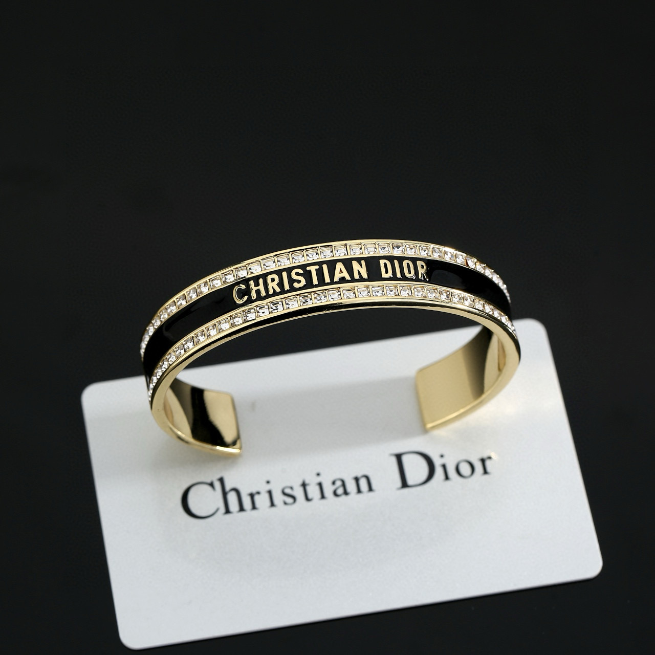 Dior Christian Dior CD Signature Enamel Crystal Cuff bracelet Gold-tone metal with clear crystals available in black enamel or white enamel variants One Size open cuff standard 17cm inner circumference