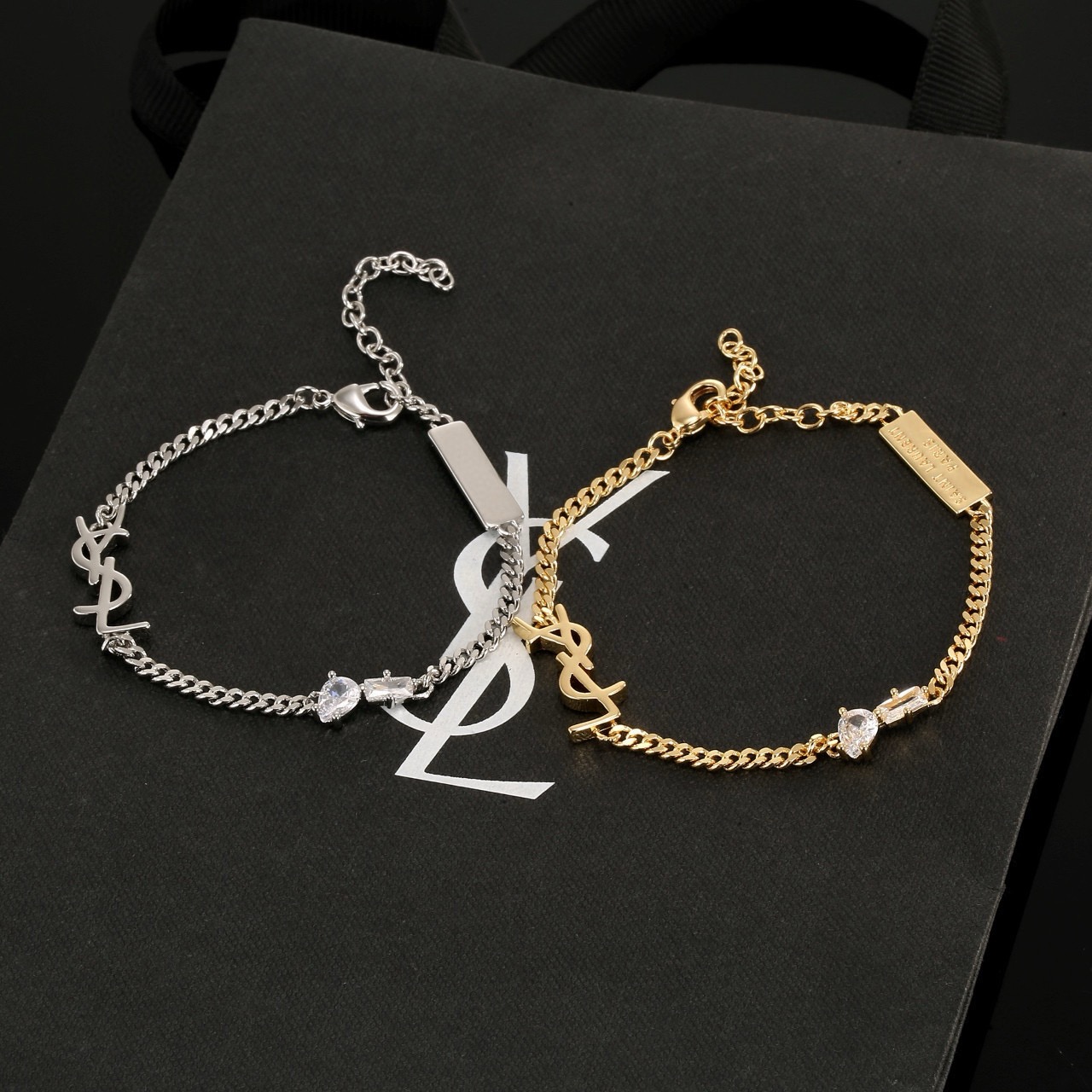 Saint Laurent YSL Monogram Logo Tag bracelet silver-toned metal with clear cubic zirconia stones 16cm with 5cm extension chain