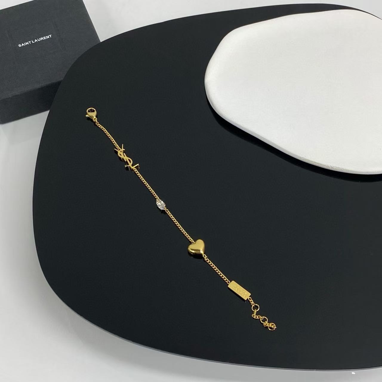 Saint Laurent Cassandre Heart Crystal Charm bracelet gold-tone metal with clear faceted crystal 19cm with 2cm extender