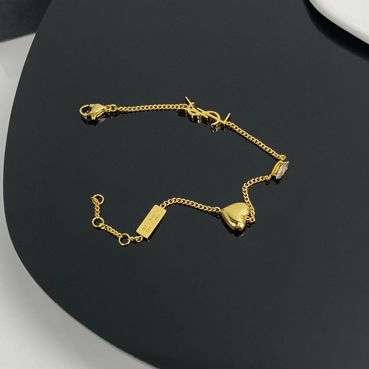 Saint Laurent Cassandre Heart Crystal Charm bracelet gold-tone metal with clear faceted crystal 19cm with 2cm extender