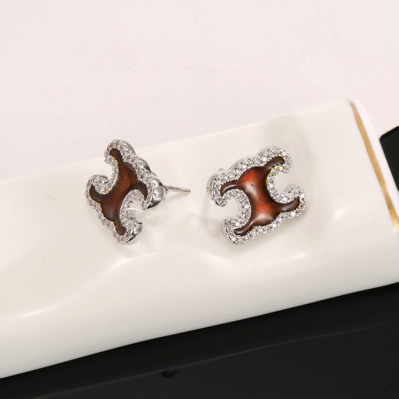 Celine Triomphe earrings gold-tone metal with brown enamel center and clear crystal accents 1 2cm stud diameter