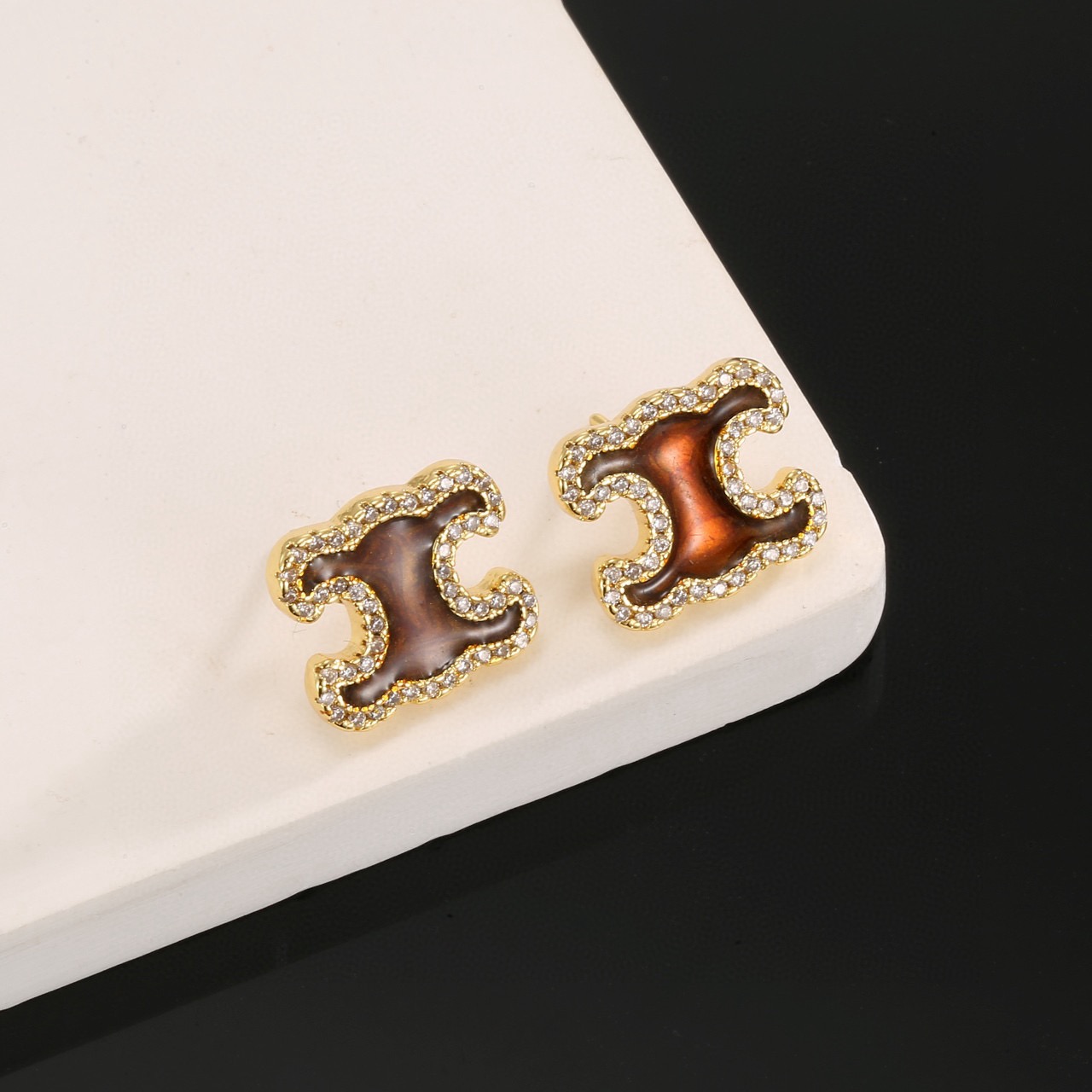Celine Triomphe earrings gold-tone metal with brown enamel center and clear crystal accents 1 2cm stud diameter