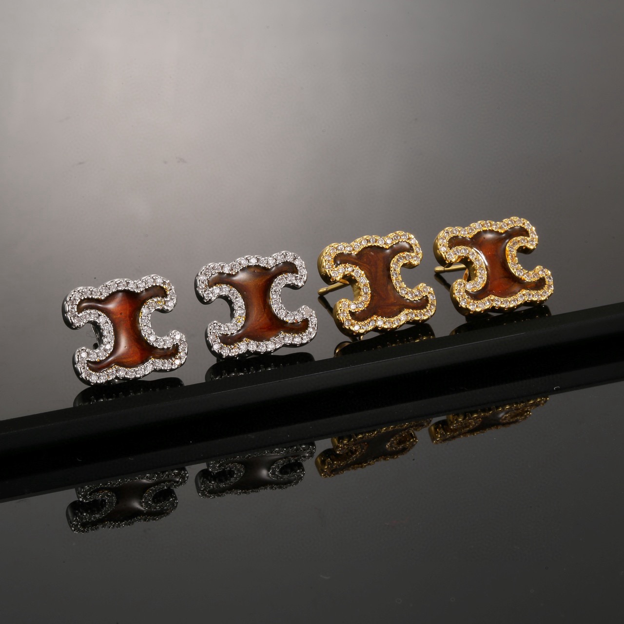 Celine Triomphe earrings gold-tone metal with brown enamel center and clear crystal accents 1 2cm stud diameter