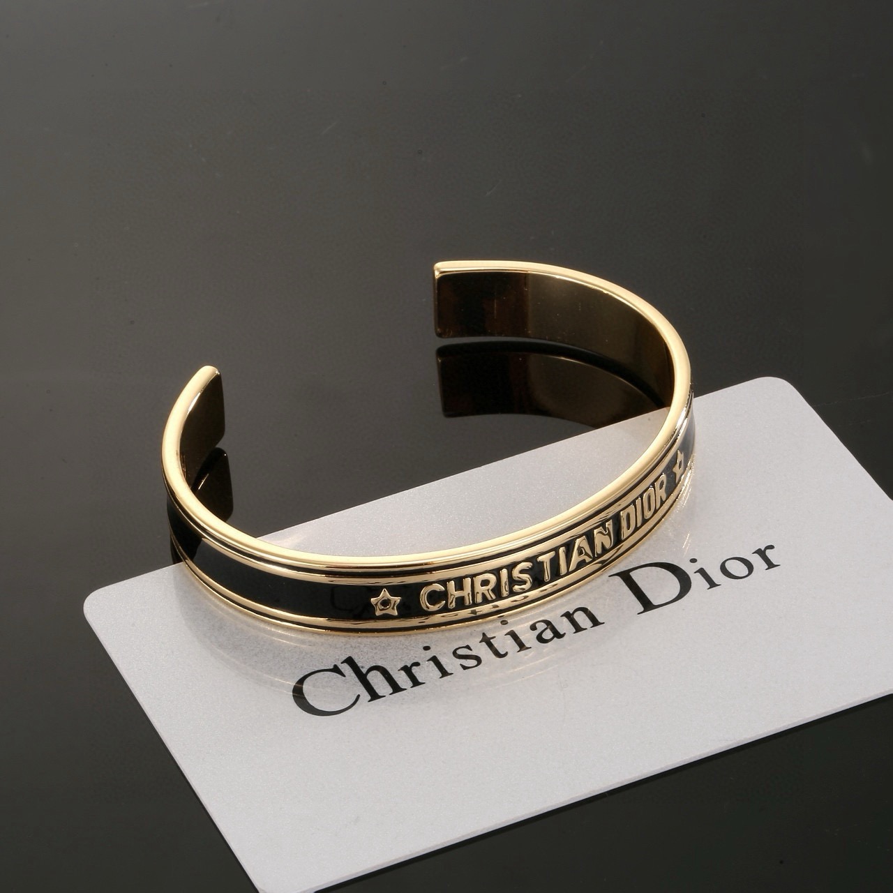Dior Christian Dior Code Star Cuff bracelet gold-tone metal with black enamel 17cm inner circumference