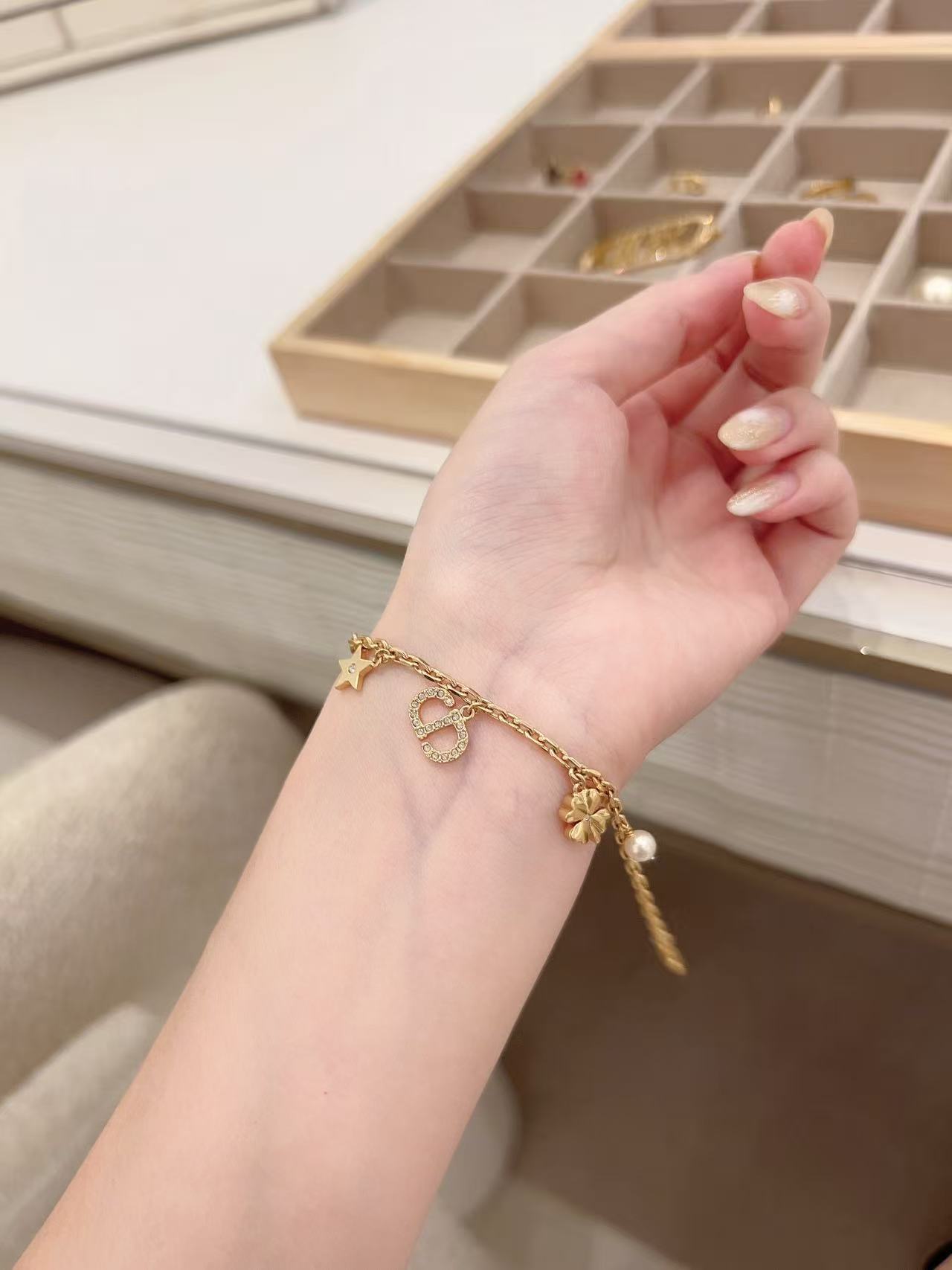 Dior Petit CD Lucky Charms bracelet Gold-tone metal with clear crystal accents and white faux pearl charm 17cm