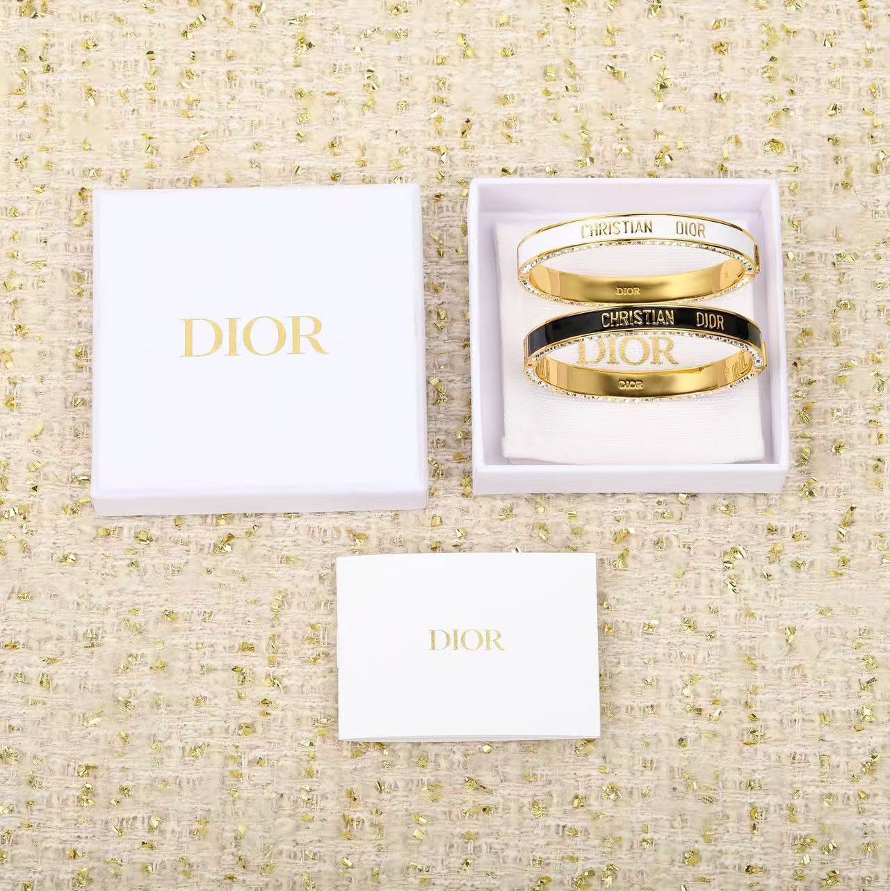 Dior Christian Dior Code Bangle bracelet Gold-tone metal with clear crystal accents available in black enamel and white enamel variants 17cm inner circumference