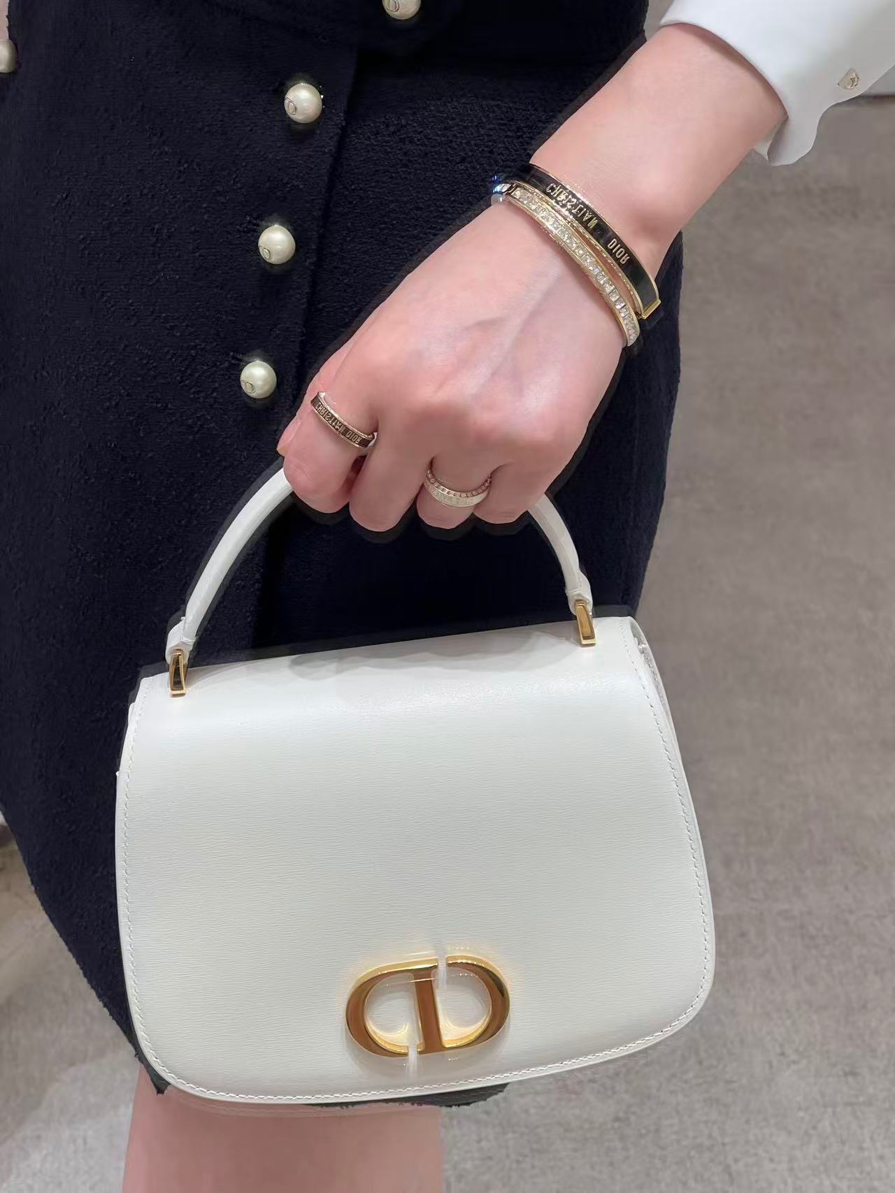 Dior Christian Dior Code Bangle bracelet Gold-tone metal with clear crystal accents available in black enamel and white enamel variants 17cm inner circumference