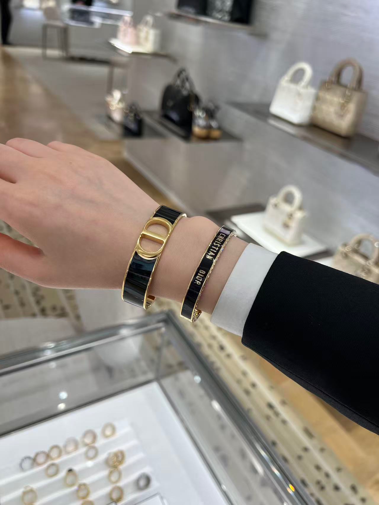 Dior Christian Dior Code Bangle bracelet Gold-tone metal with clear crystal accents available in black enamel and white enamel variants 17cm inner circumference