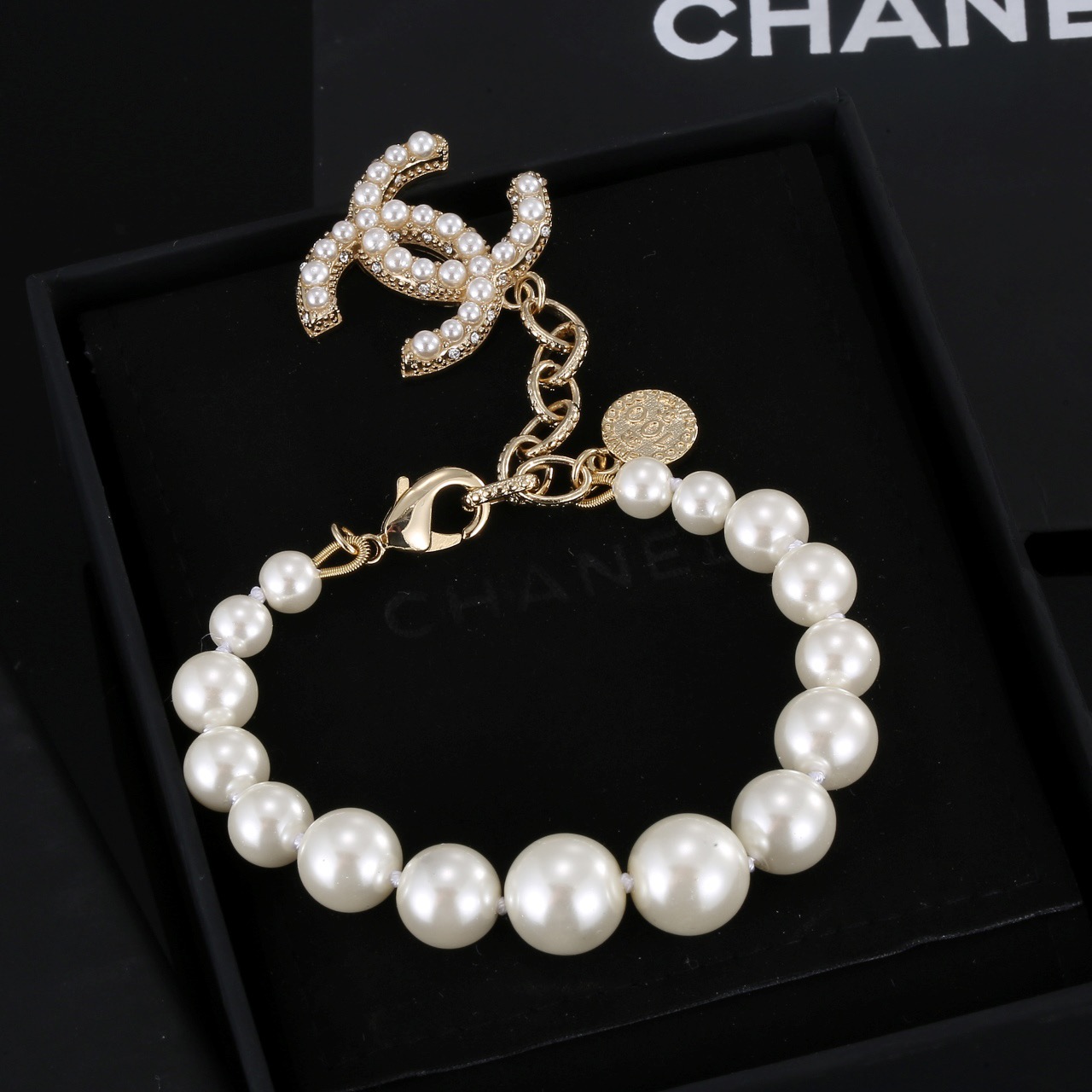 Chanel CC Pearl Charm Bracelet bracelet Gold-tone metal with white faux pearls and clear crystal accents 18cm