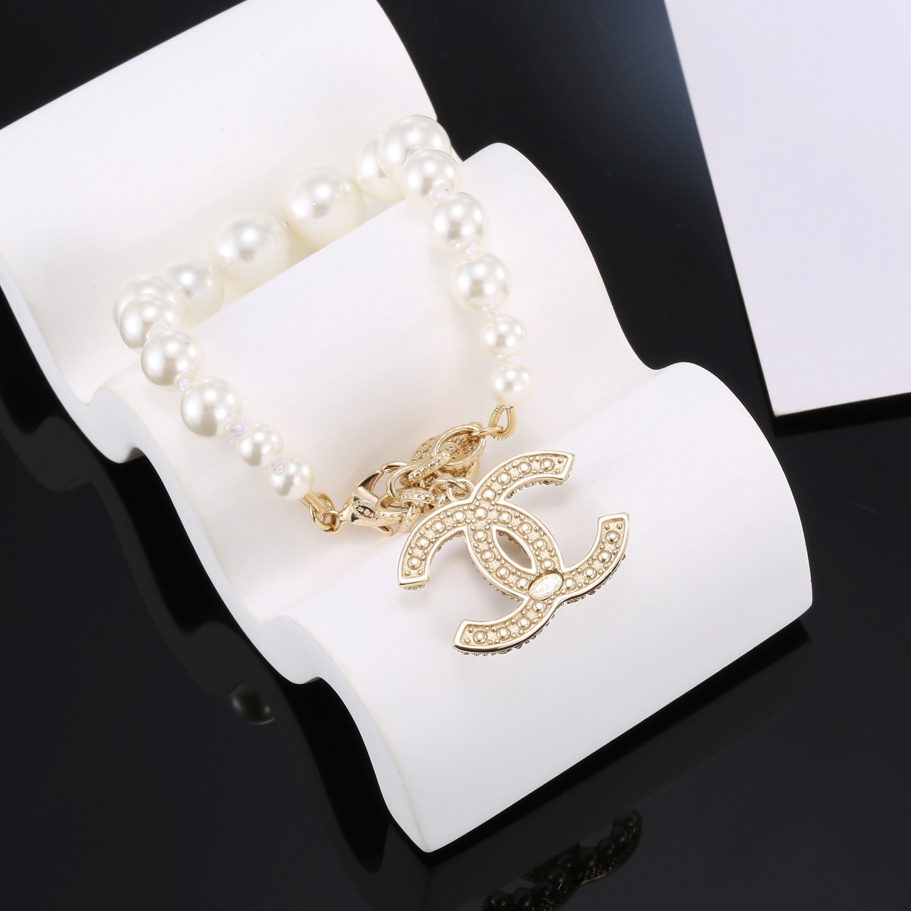 Chanel CC Pearl Charm Bracelet bracelet Gold-tone metal with white faux pearls and clear crystal accents 18cm