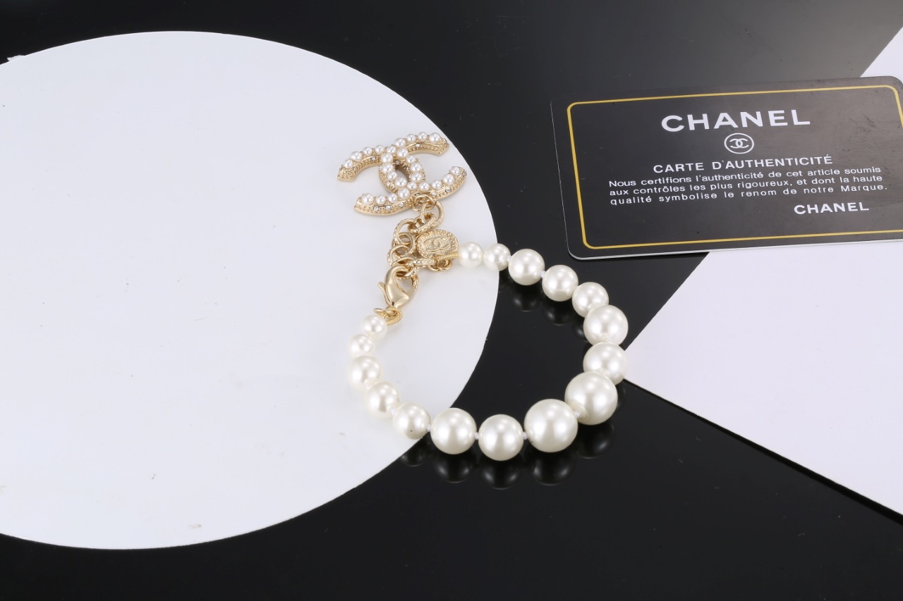 Chanel CC Pearl Charm Bracelet bracelet Gold-tone metal with white faux pearls and clear crystal accents 18cm