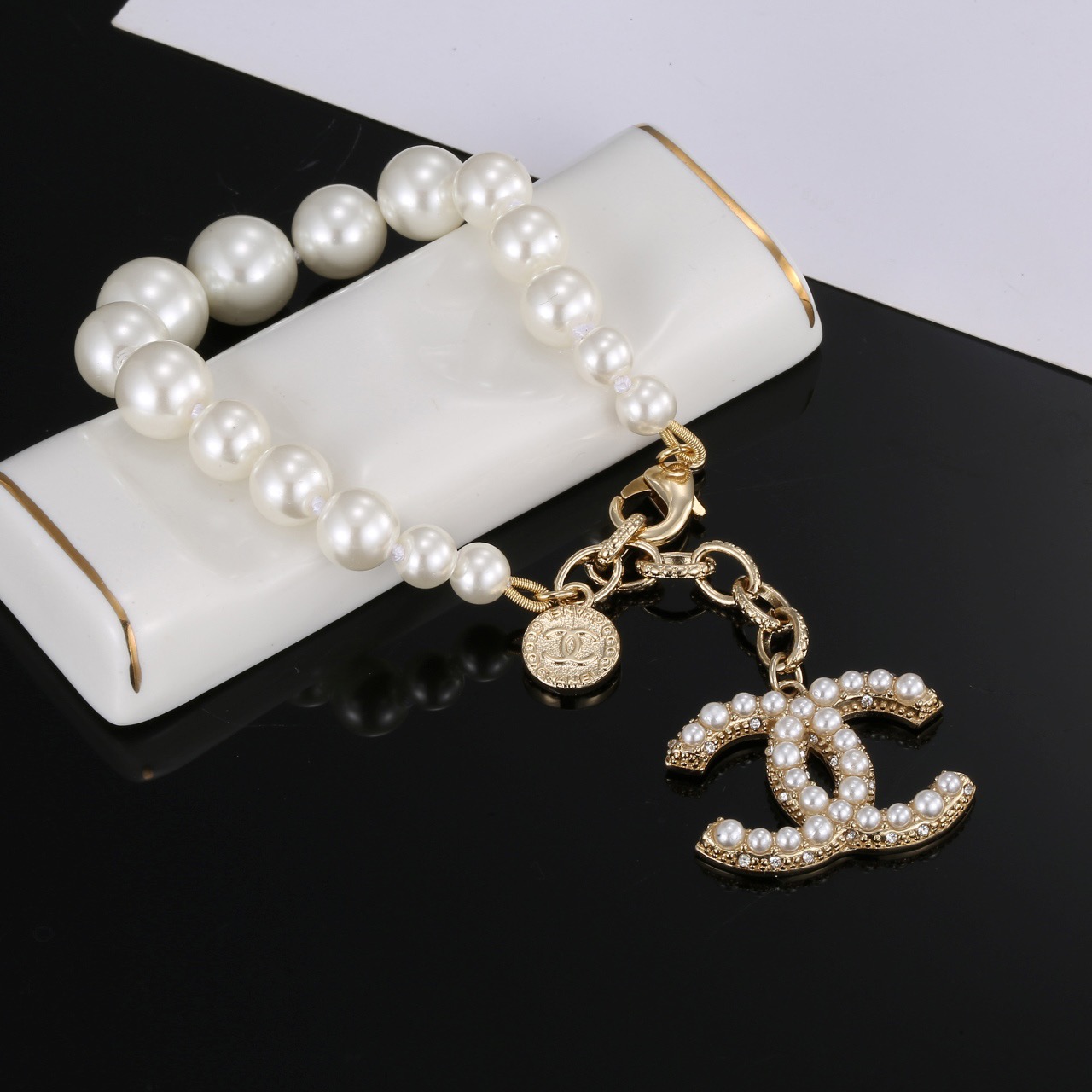 Chanel CC Pearl Charm Bracelet bracelet Gold-tone metal with white faux pearls and clear crystal accents 18cm