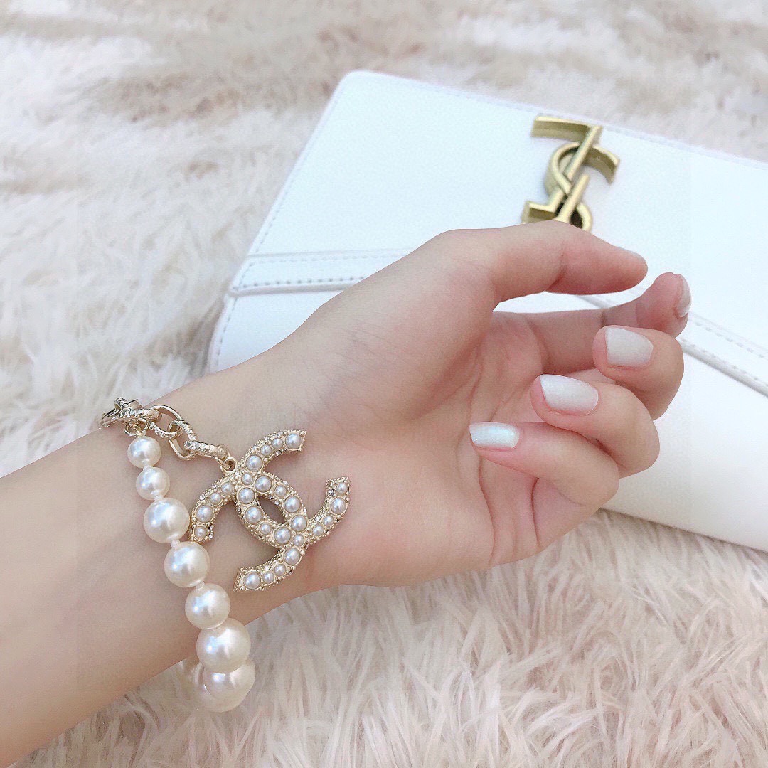 Chanel CC Pearl Charm Bracelet bracelet Gold-tone metal with white faux pearls and clear crystal accents 18cm