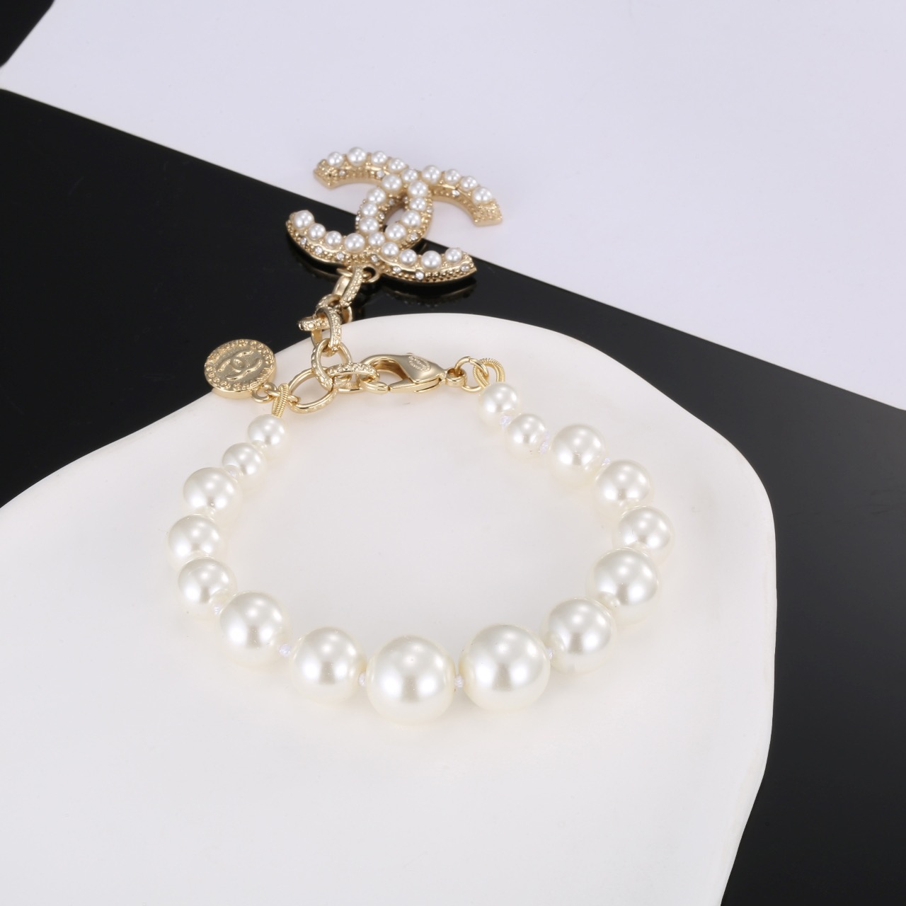 Chanel CC Pearl Charm Bracelet bracelet Gold-tone metal with white faux pearls and clear crystal accents 18cm