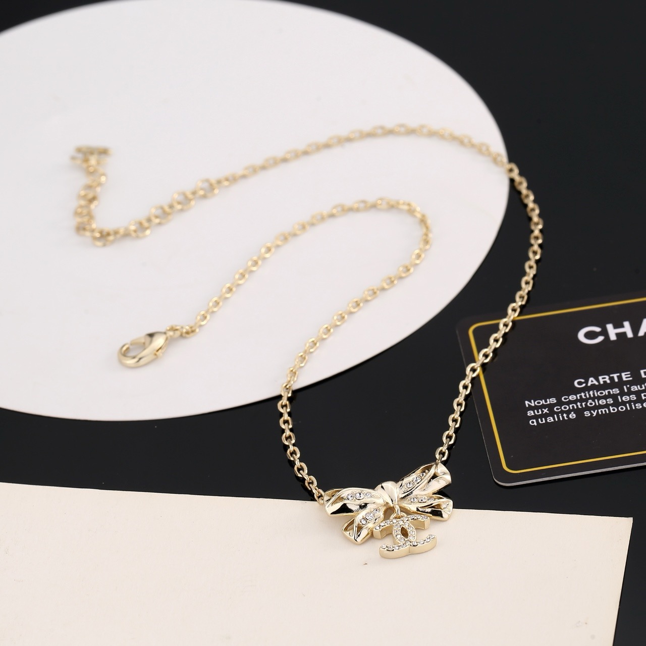 Chanel Crystal Bow CC Pendant Necklace necklace Light gold tone metal with clear crystal accents 42cm with 5cm extender