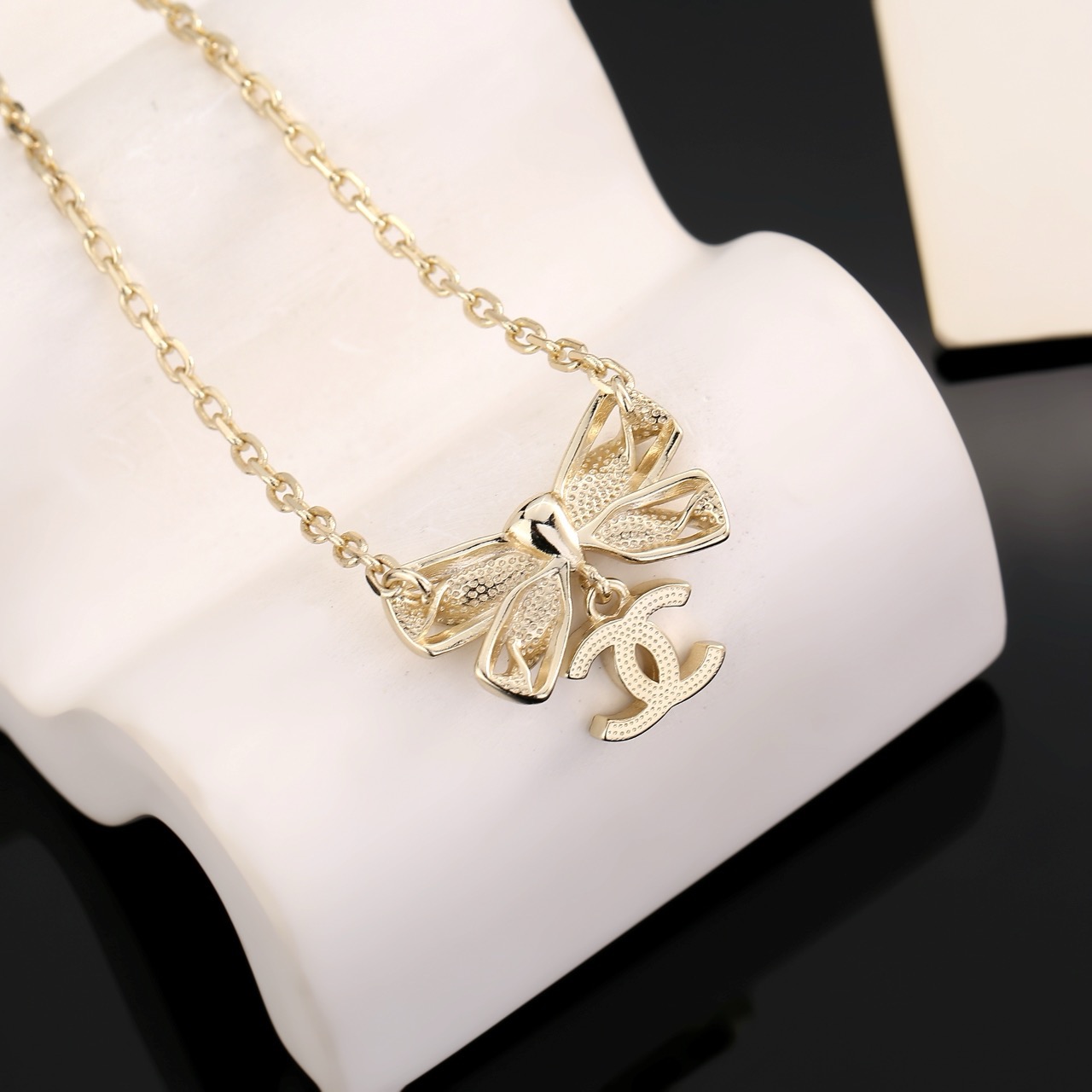 Chanel Crystal Bow CC Pendant Necklace necklace Light gold tone metal with clear crystal accents 42cm with 5cm extender