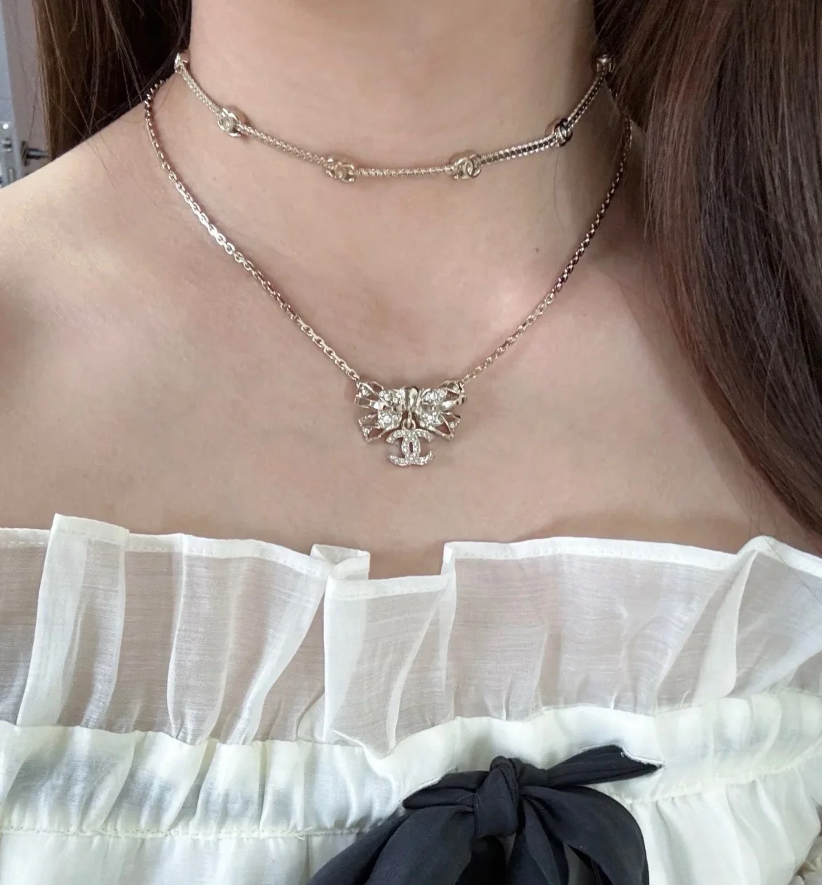 Chanel Crystal Bow CC Pendant Necklace necklace Light gold tone metal with clear crystal accents 42cm with 5cm extender