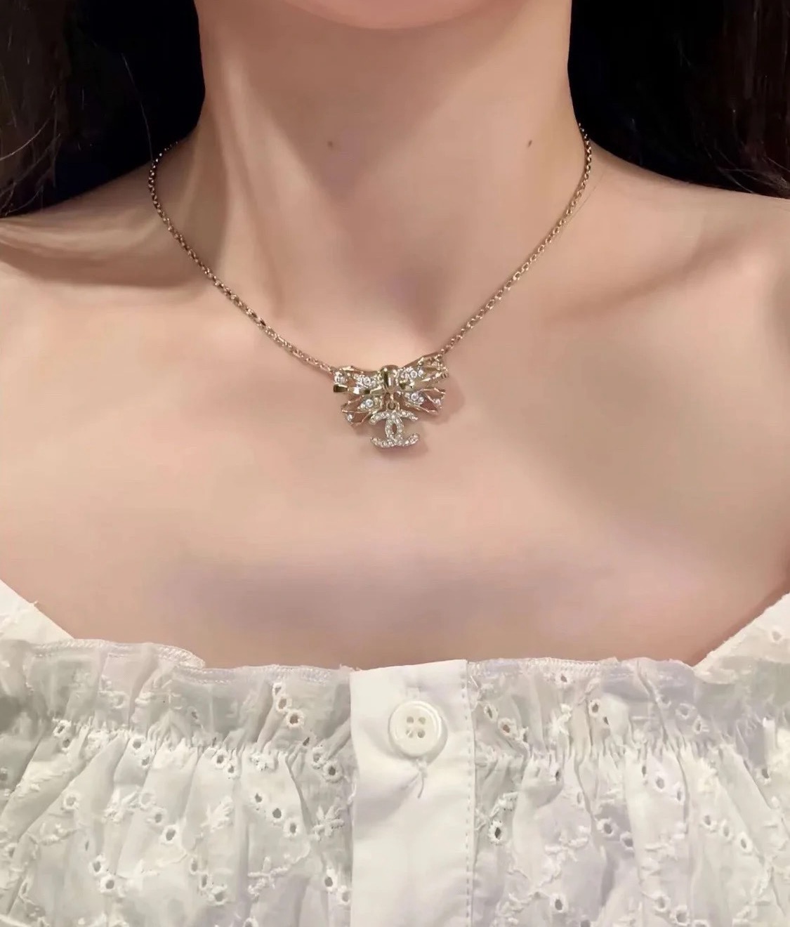 Chanel Crystal Bow CC Pendant Necklace necklace Light gold tone metal with clear crystal accents 42cm with 5cm extender
