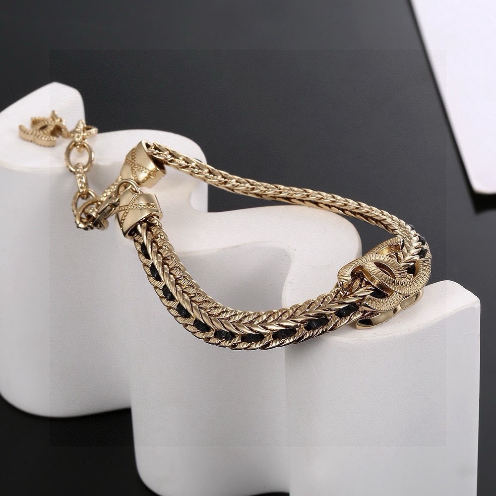 Chanel CC Crystal Woven Chain Bracelet bracelet Light gold tone metal with black woven leather inlay and clear crystal accents 18cm with 5cm extension