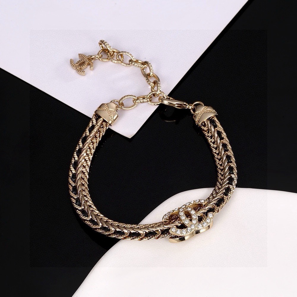 Chanel CC Crystal Woven Chain Bracelet bracelet Light gold tone metal with black woven leather inlay and clear crystal accents 18cm with 5cm extension