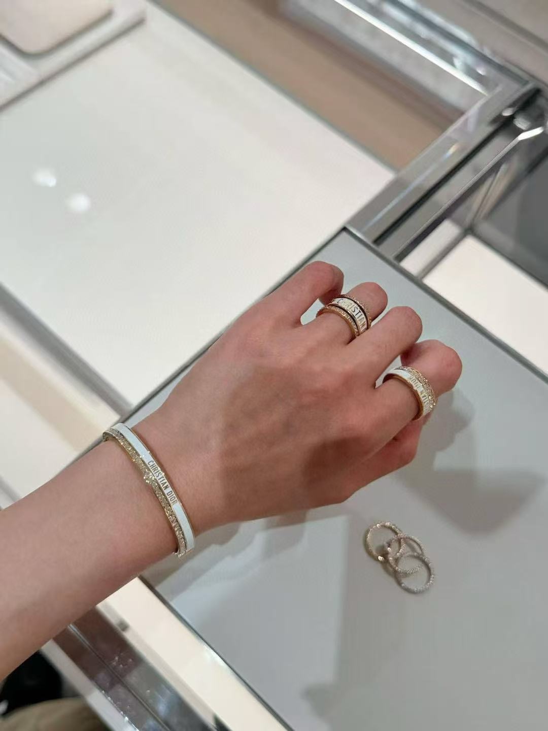 Dior CD New Night Code Bangle bracelet Gold-tone metal with clear channel-set crystals available with white or black enamel accent M